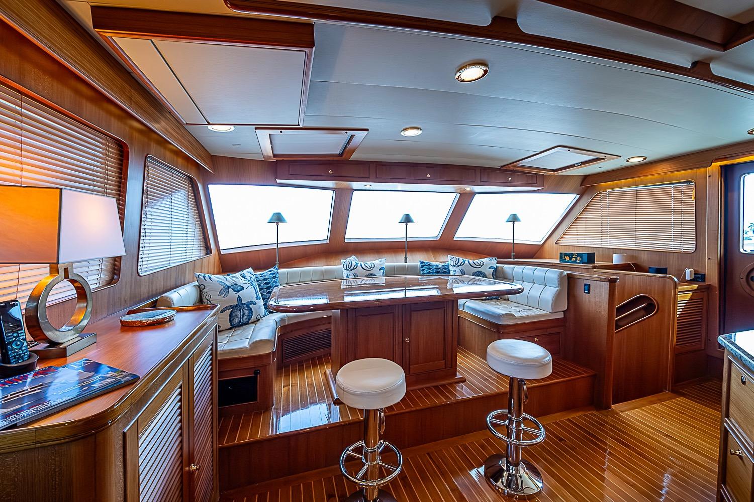 Luxurious interior of 2014 Marlow 80 Explorer yacht with elegant wood finishes and seating.