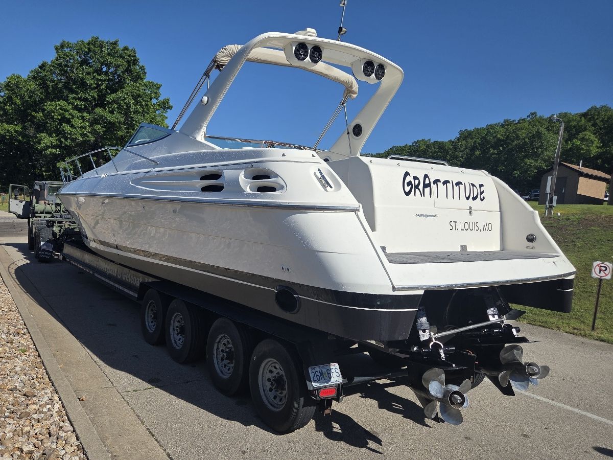 A white boat on a trailer with the name "Grattitude" on the stern.