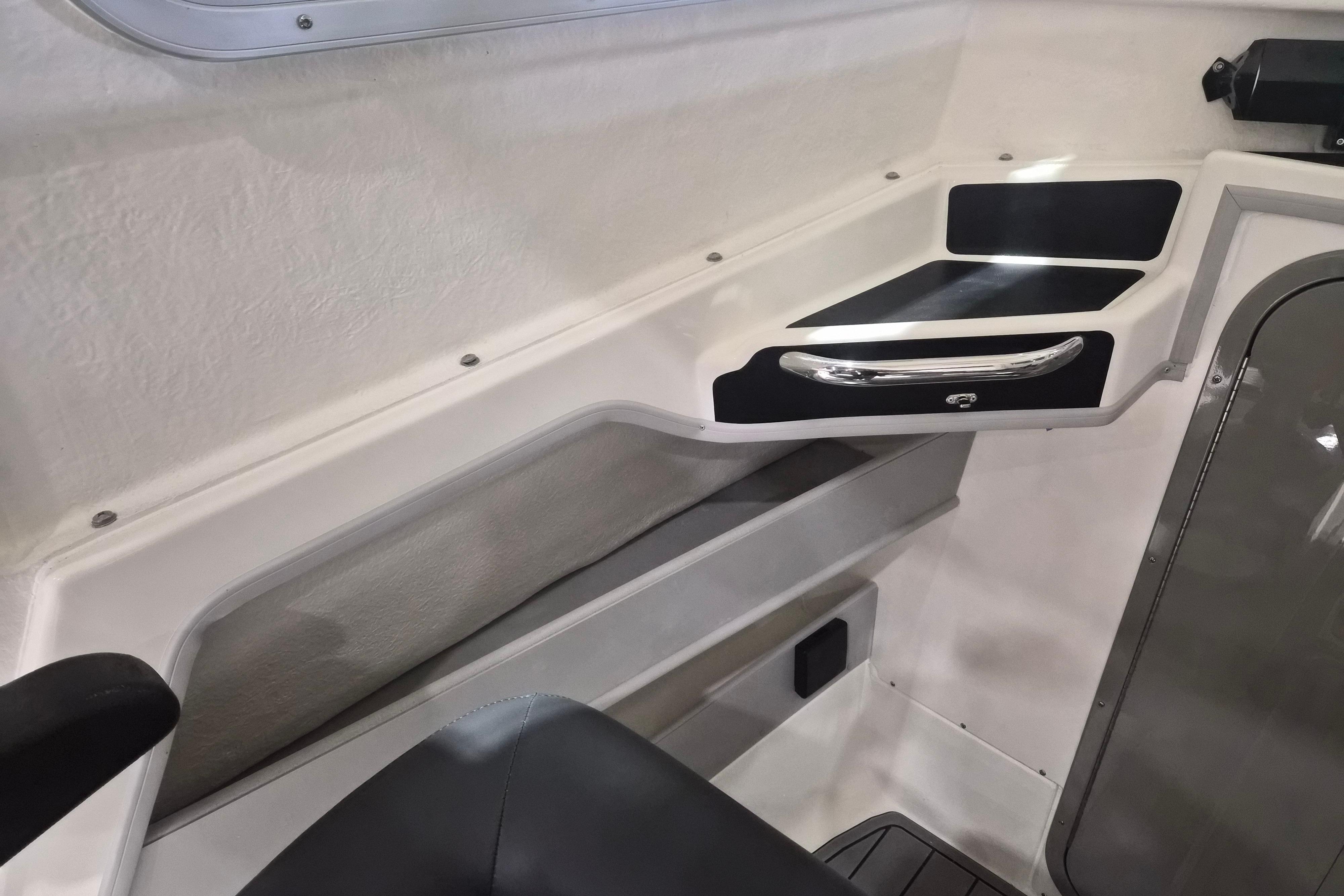 Interior view of 2026 Arima Sea Chaser 19 Yellowtail Edition boat, featuring sleek storage compartments.