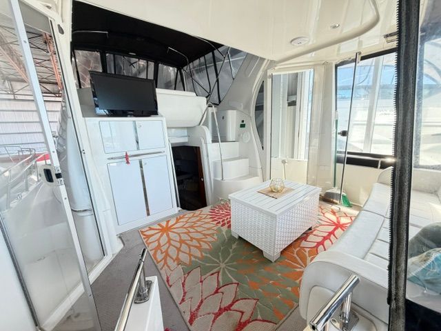 Interior of a 2005 Carver 44 Cockpit Motor Yacht with a rug and sofa.