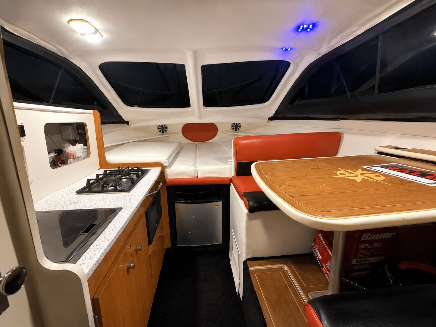 Interior of a 2001 Bayliner 2452 Ciera Classic with a kitchen and seating area.