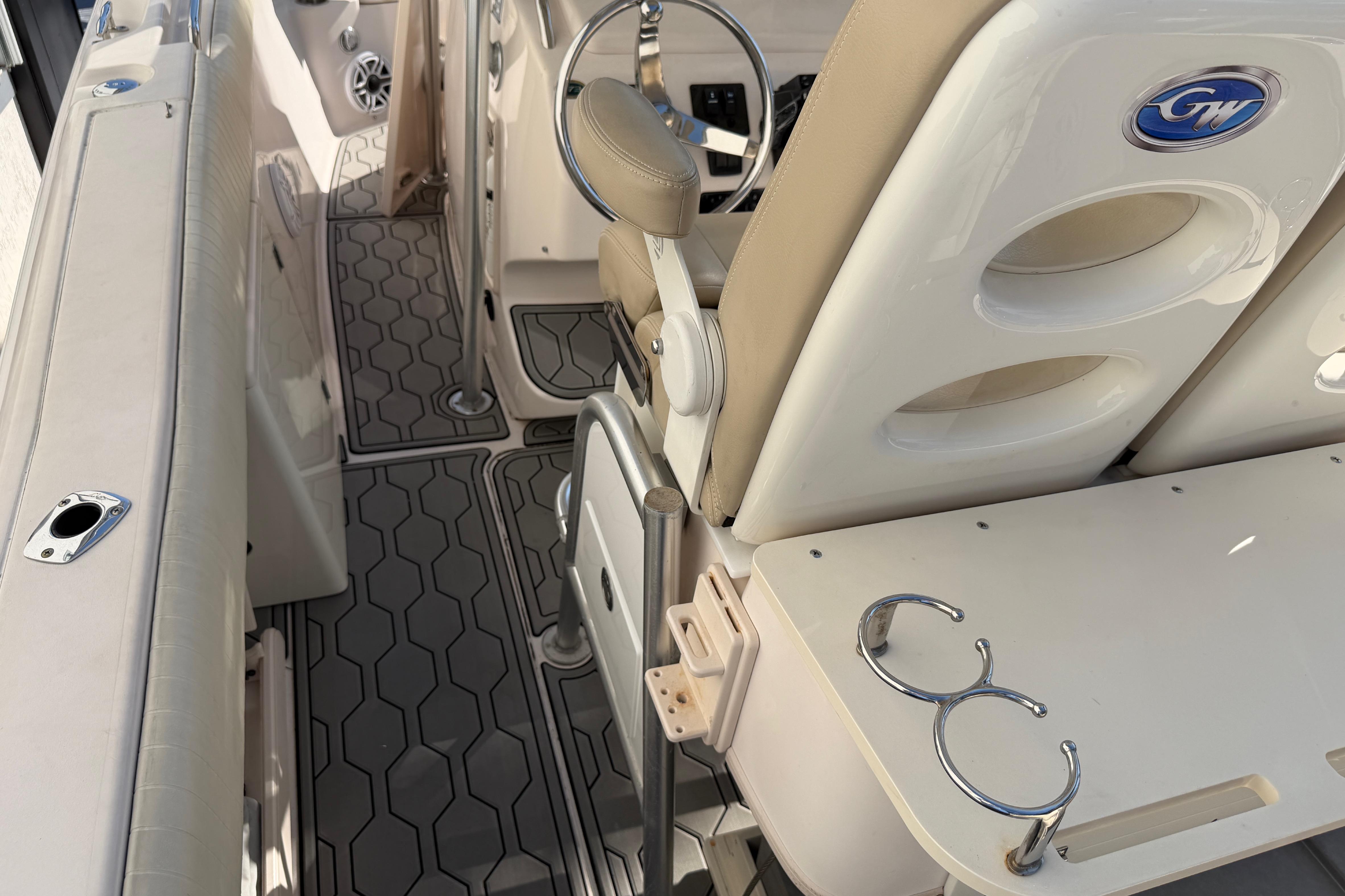 2004 Grady White 273 boat interior with seating, cup holders, and non-slip flooring.