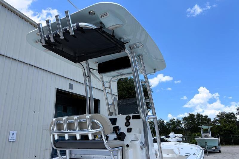 2025 Key West 210 Bay Reef boat with T-top and rod holders under a clear blue sky.