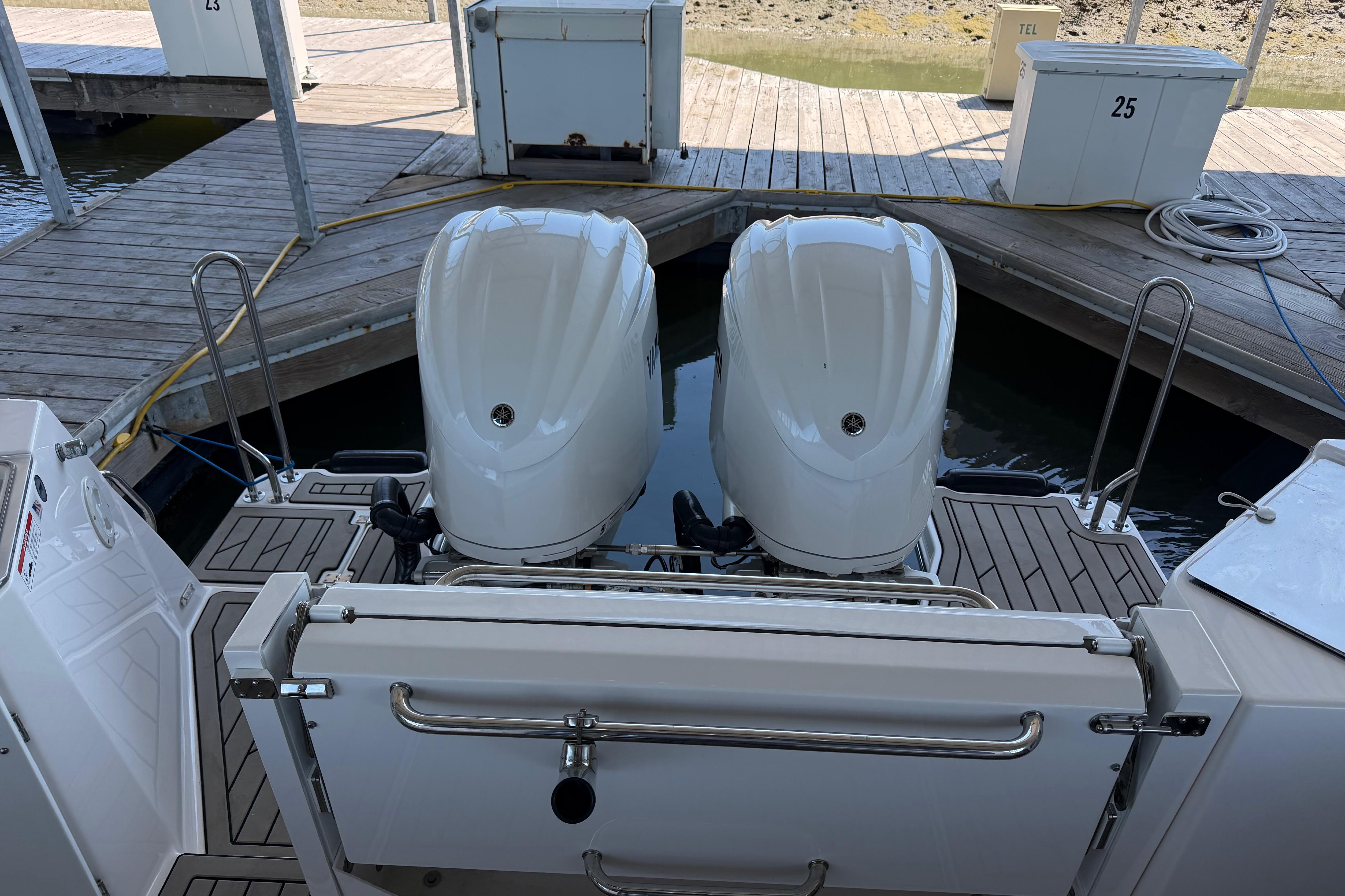 2023 Cutwater C-288 Coupe with dual outboard engines docked at a marina.