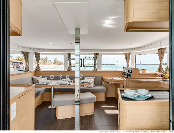 Interior of 2025 Lagoon 42 Millenium yacht with elegant dining area and panoramic windows.