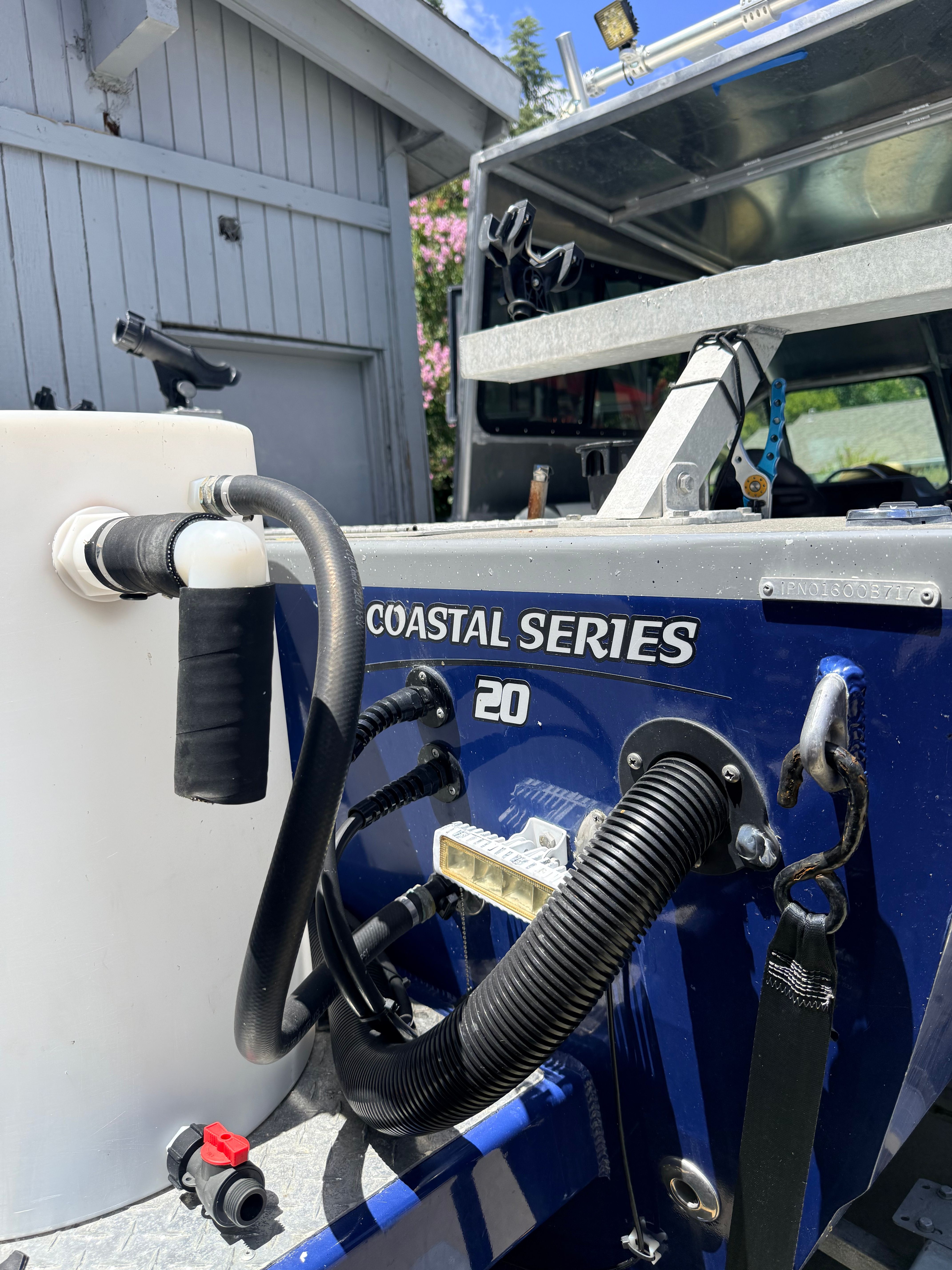 Close-up of the stern of a River Hawk Coastal Series 20’ boat with hoses and fittings.