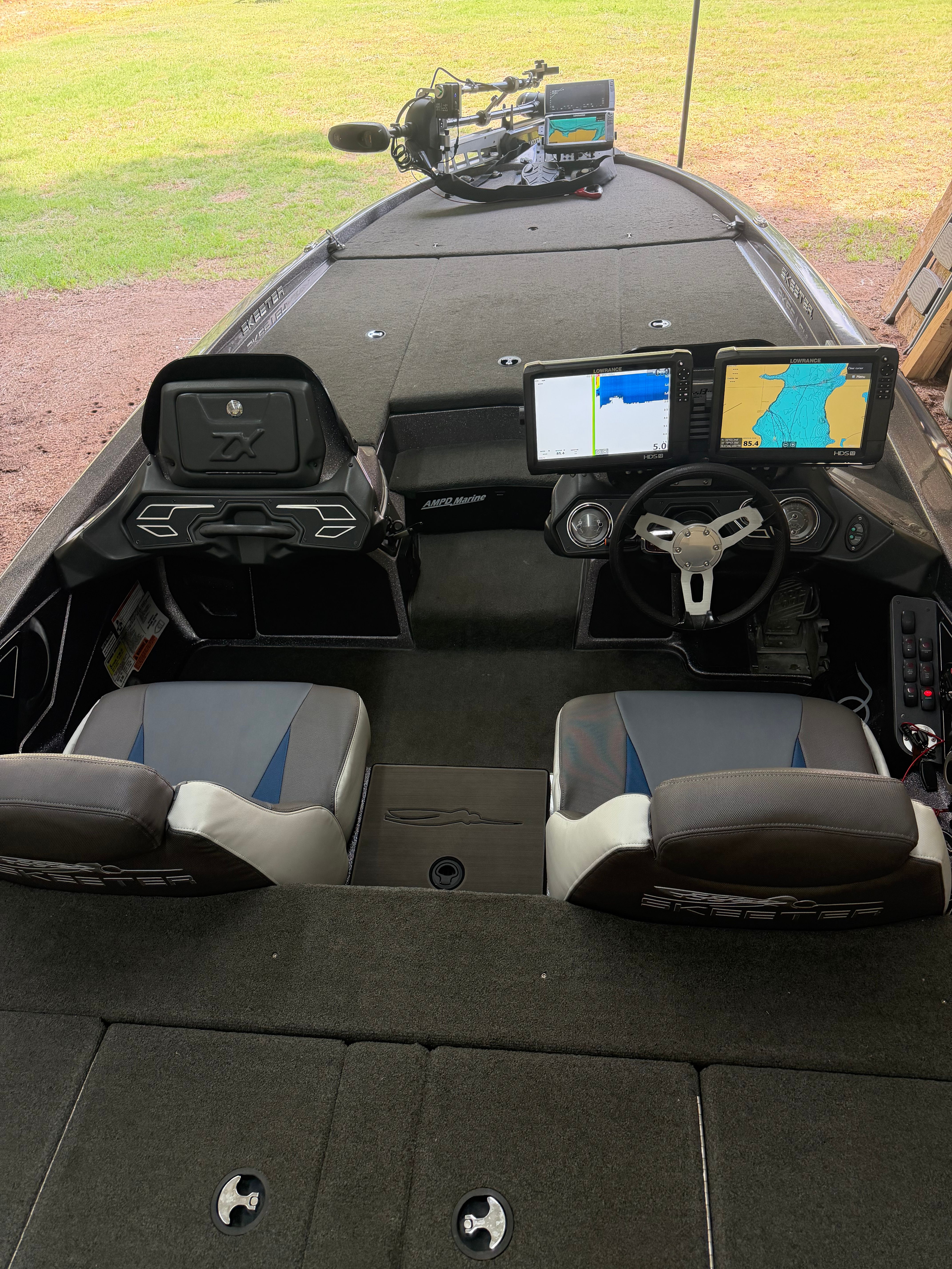 The image shows the cockpit of a 2017 Skeeter ZX250 boat with two seats and navigation equipment.