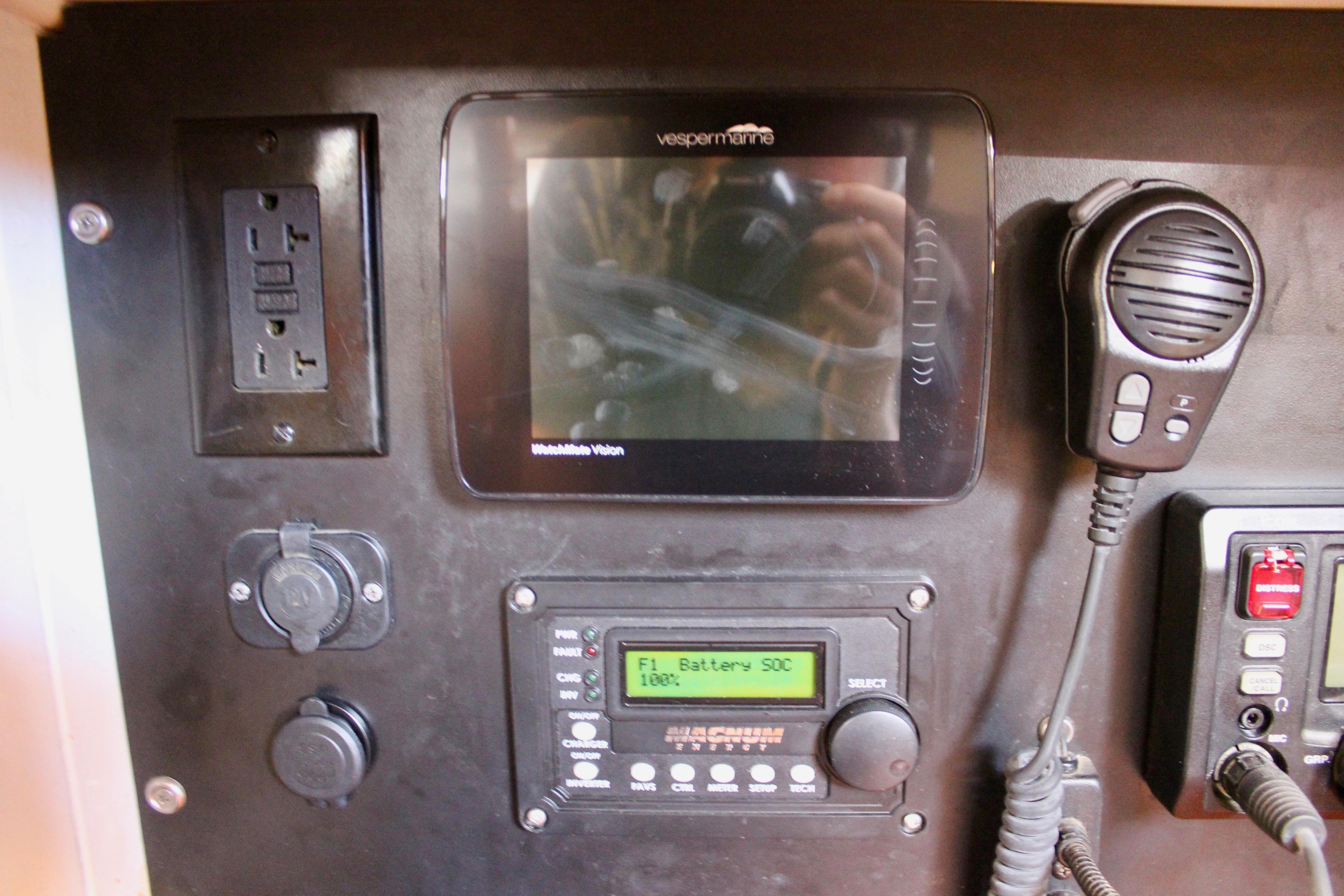 Control panel of a 1981 Kelly Peterson 46 yacht with electronic displays and communication devices.
