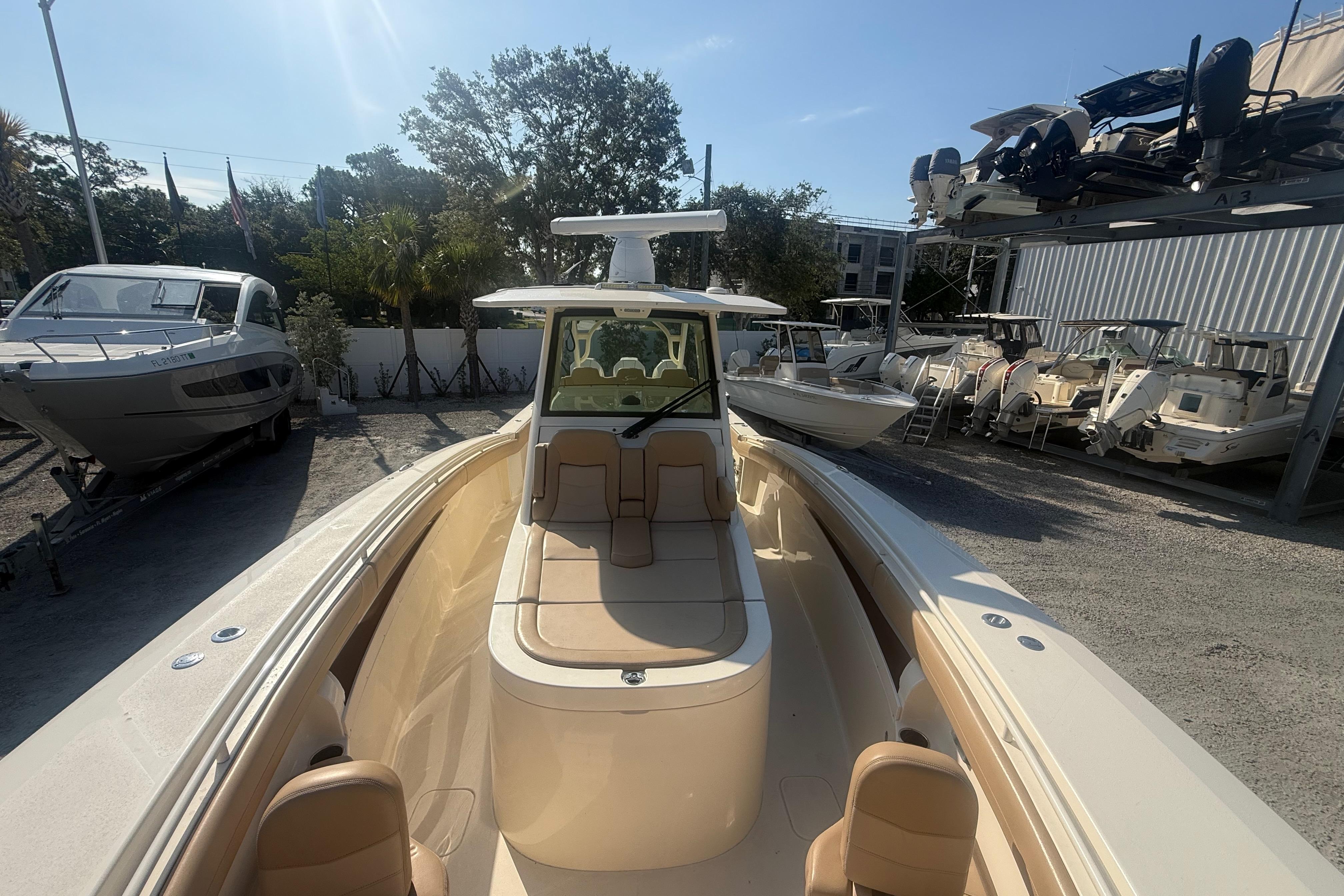 2022 Scout 355 LXF boat in a marina, surrounded by other vessels.