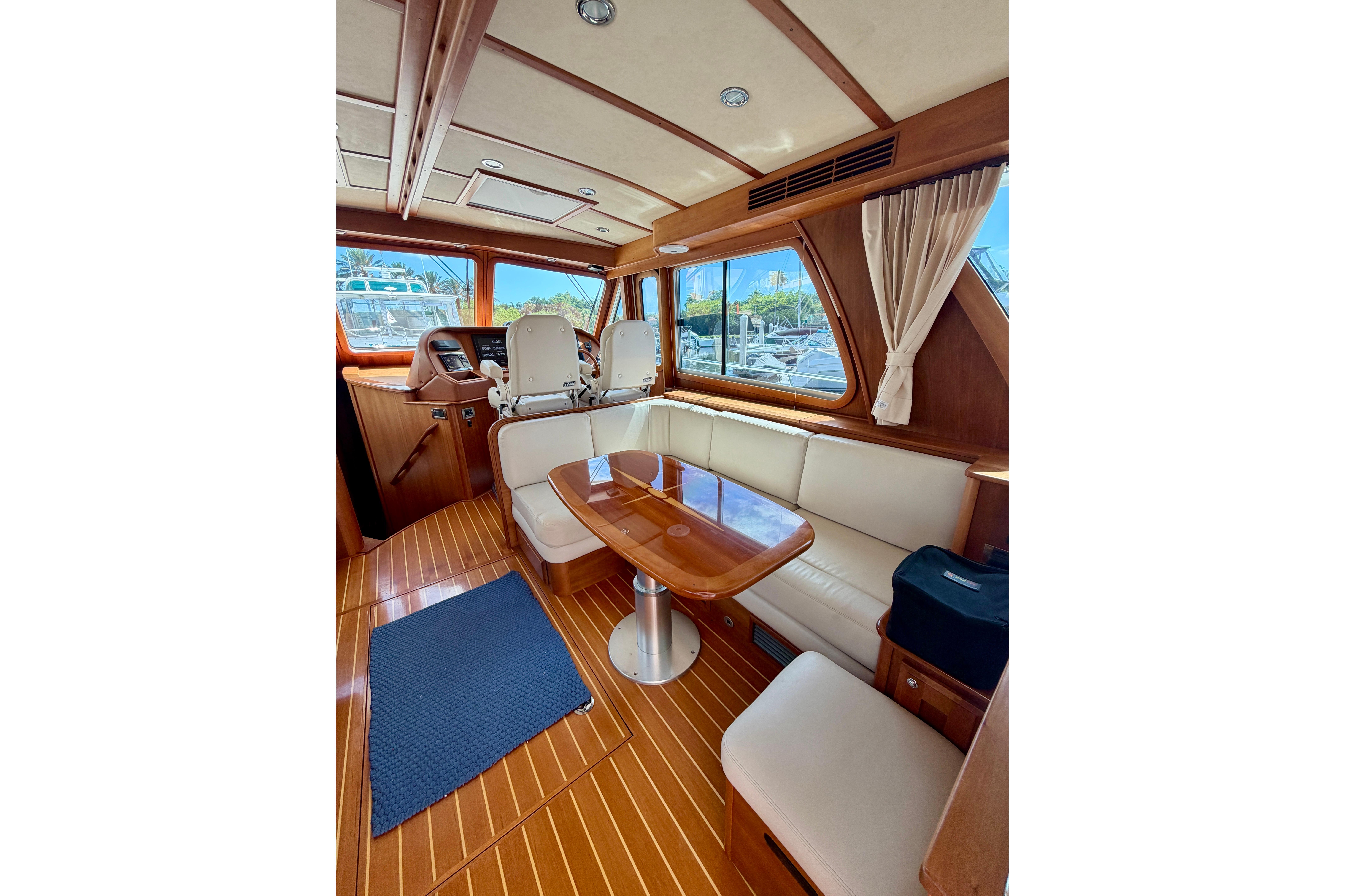 Interior of 2016 Sabre 48 Salon Express yacht with elegant wood finish and seating area.