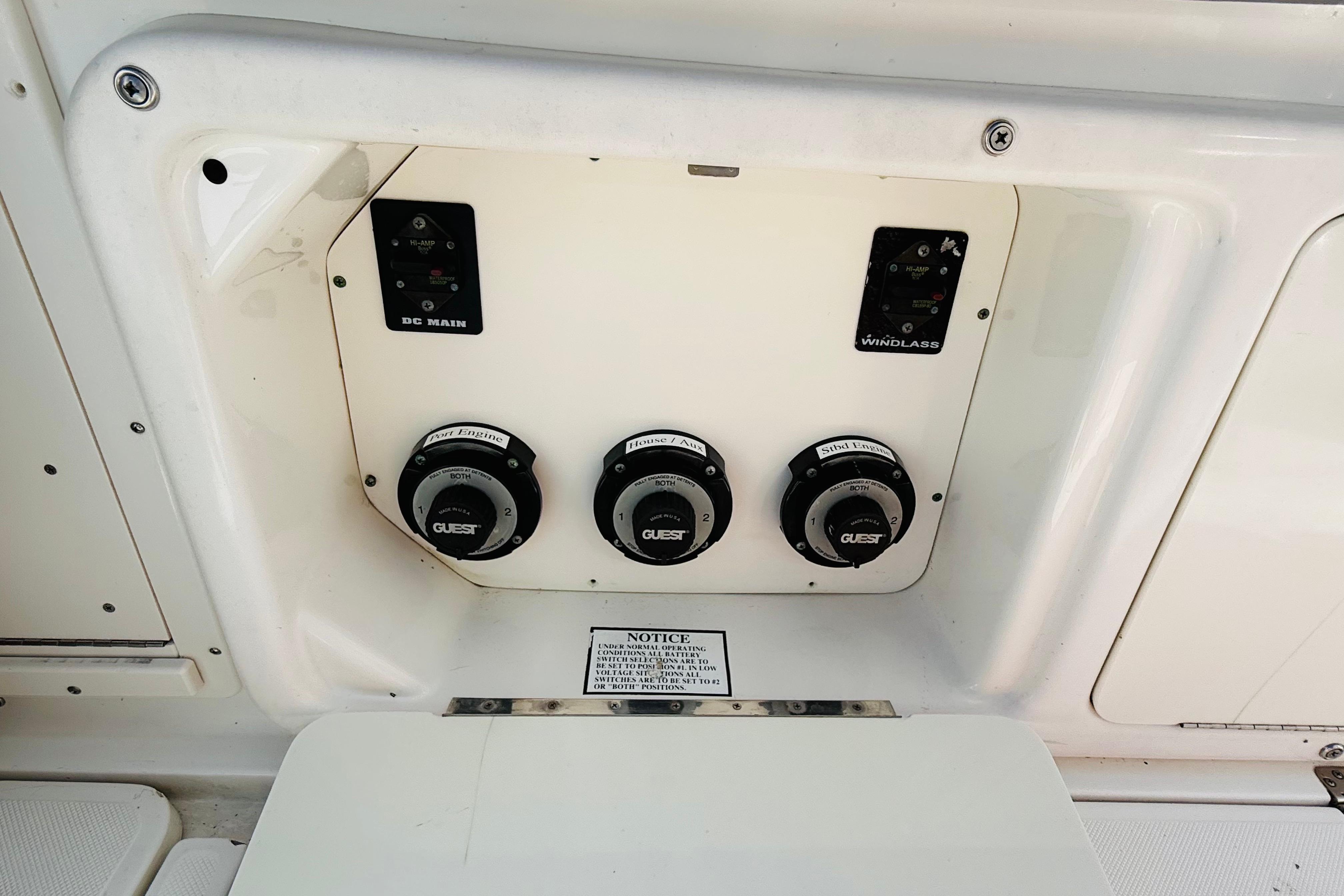 Control panel of a 2005 Century 3200 Center Console boat with switches and dials.