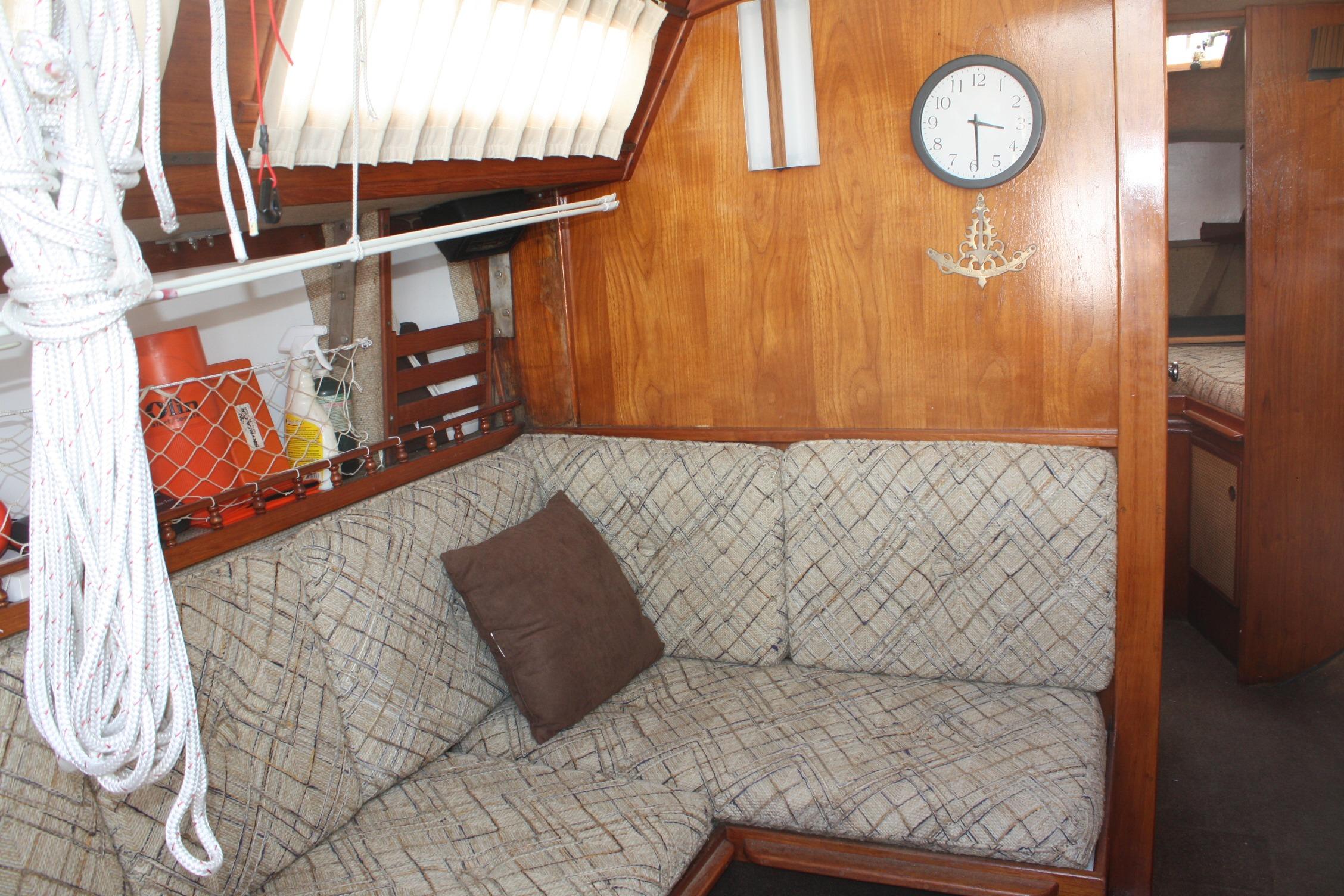 Interior of 1981 S2 9.2A sailboat with cozy seating and nautical decor.