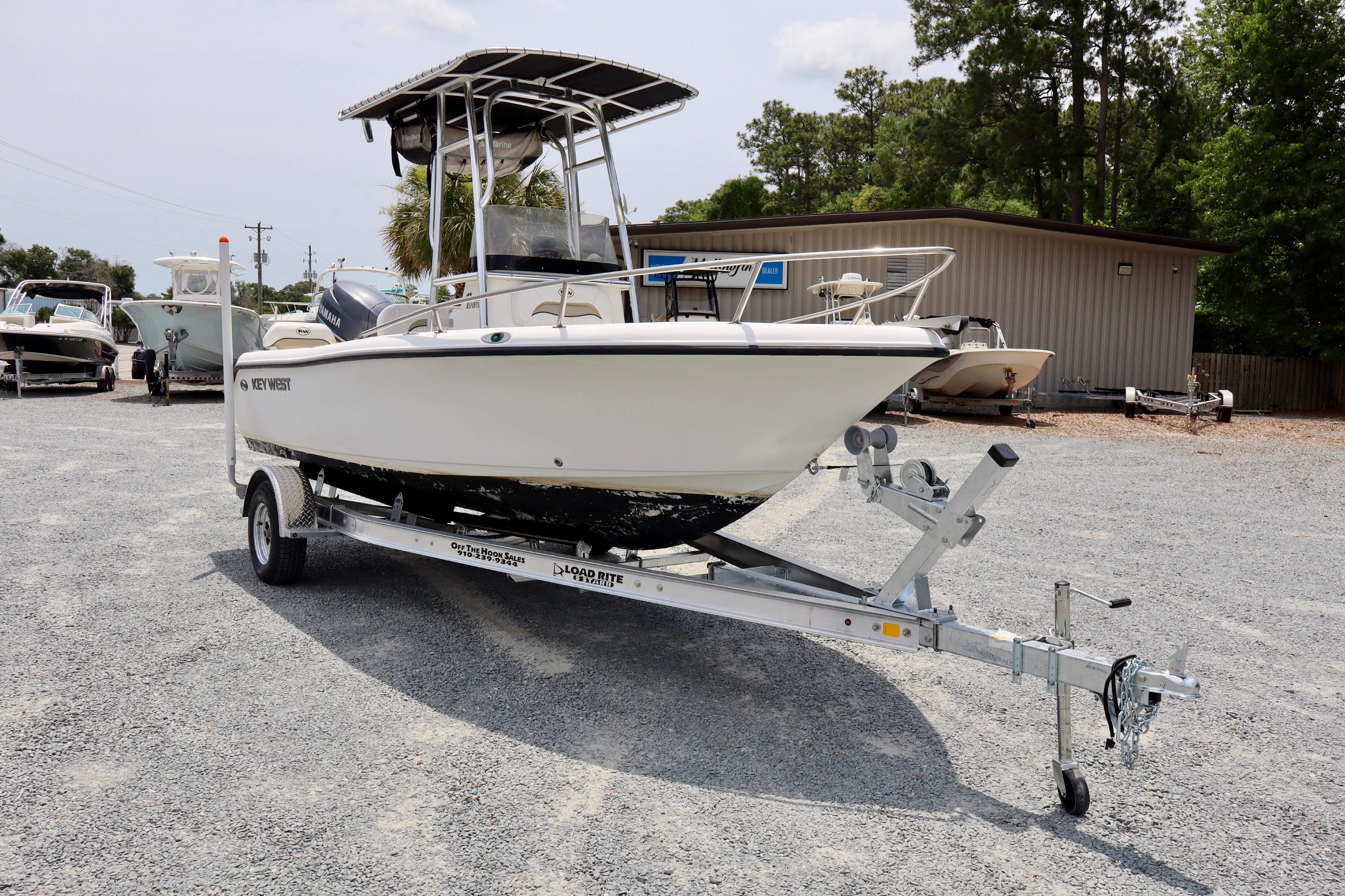 2010 Key West 186 Sportsman boat on trailer in outdoor lot.