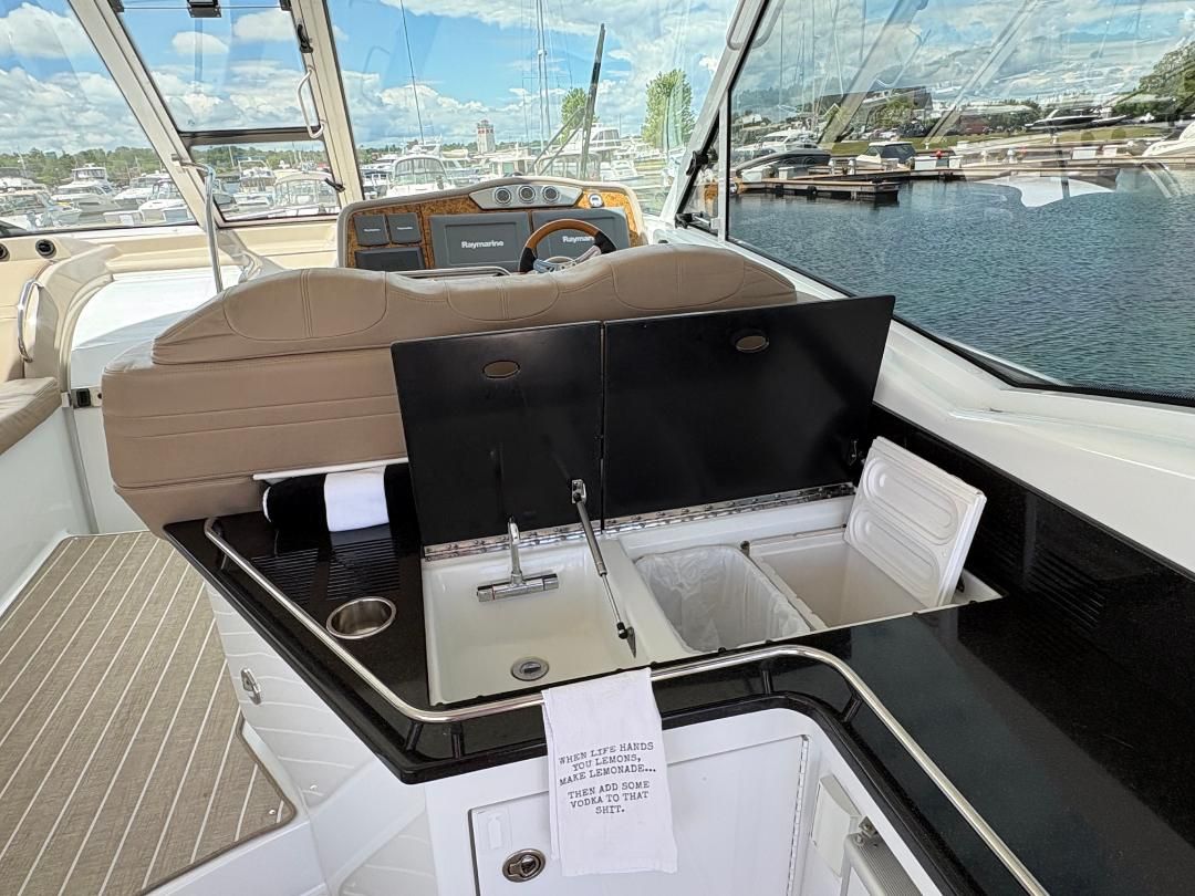 The image shows the cockpit of a 2011 Formula 45 with a sink and refrigerator.