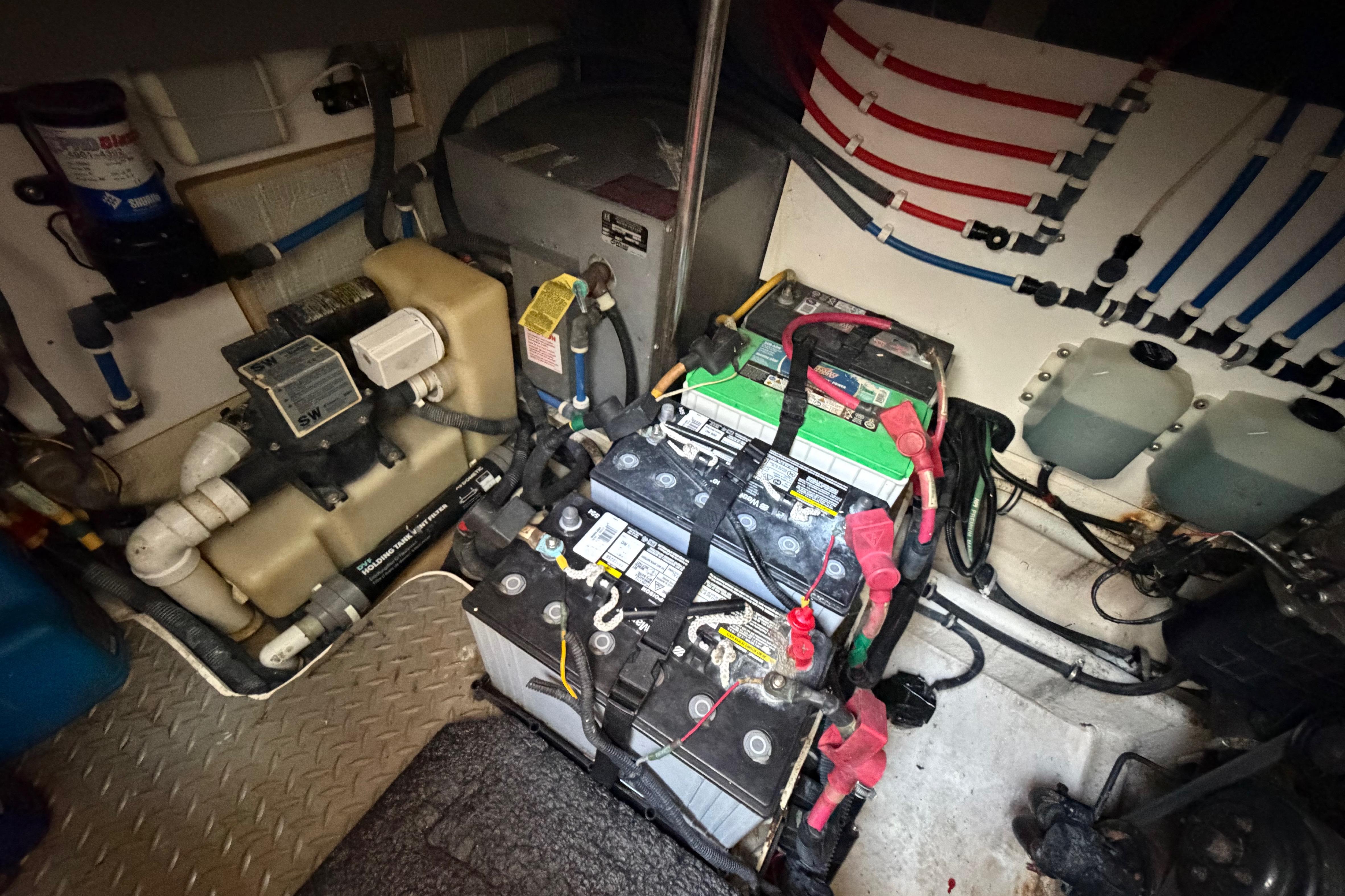 Engine room of a 2007 Monterey 350 Sport Yacht with batteries and wiring.