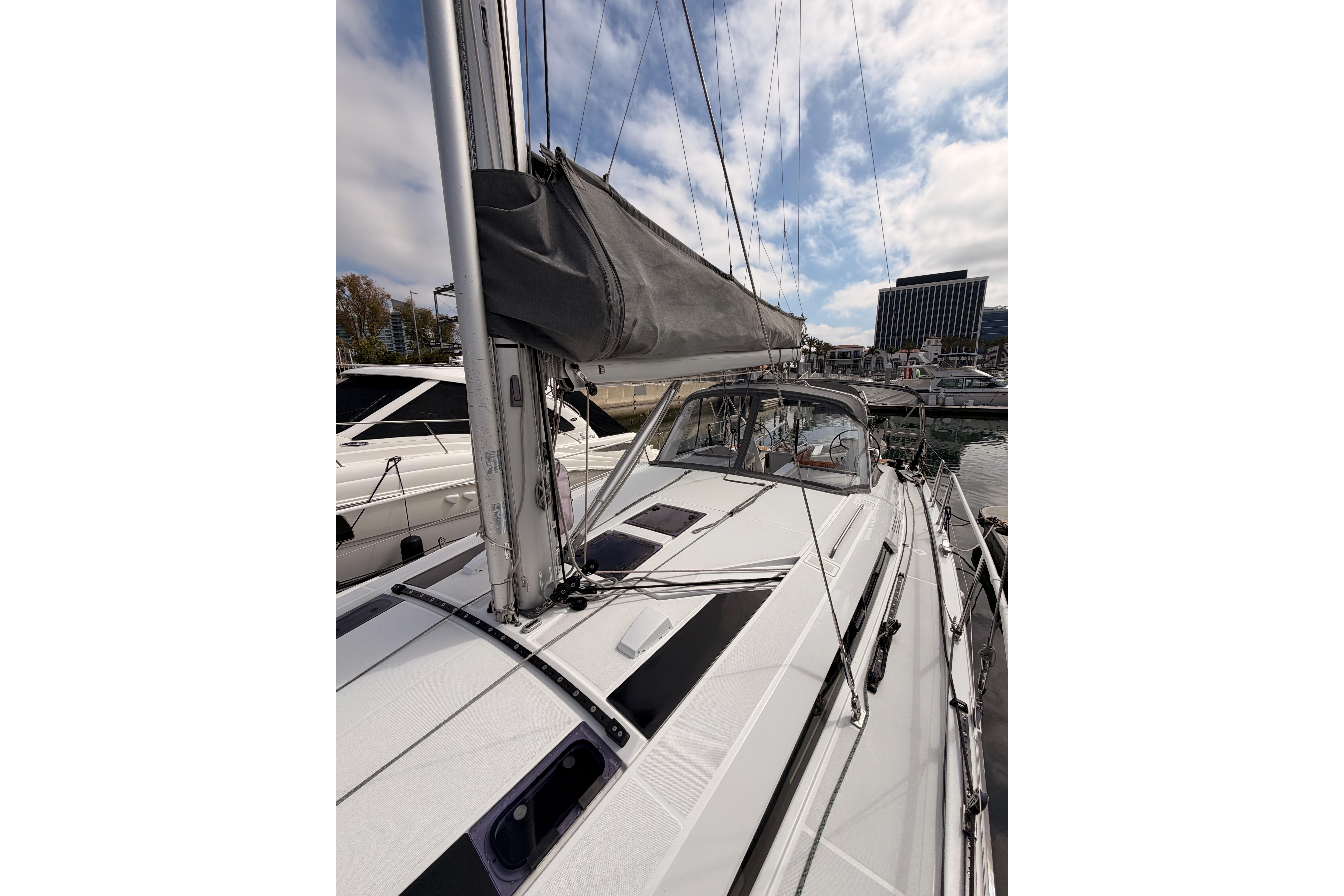 2020 Beneteau Oceanis 46.1 sailboat docked at marina under cloudy sky.