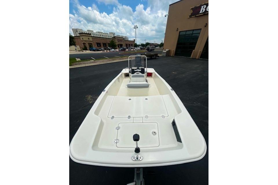2026 Mako Pro Skiff 15 CC boat displayed outdoors near a building.