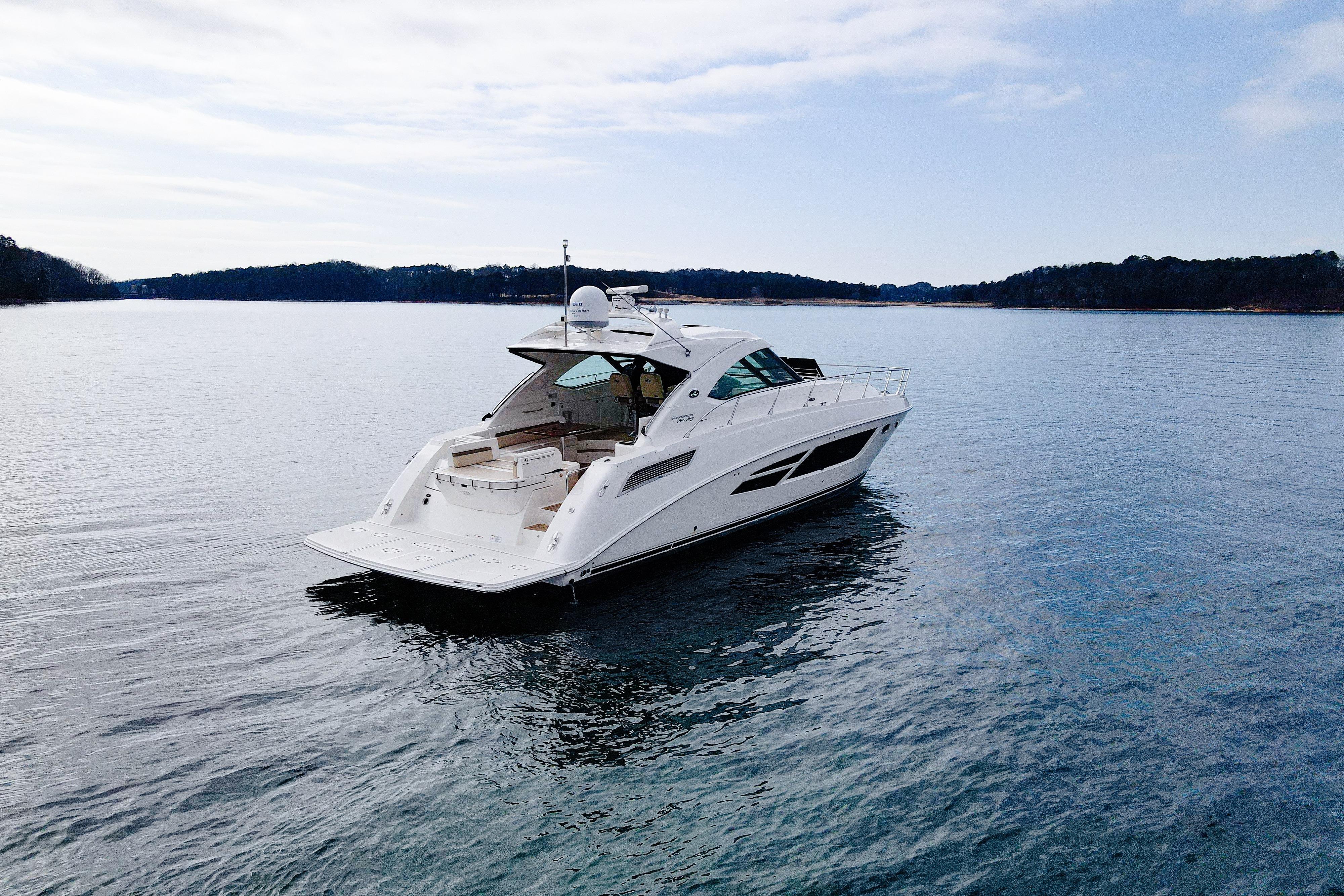 2015 Sea Ray Sundancer 540 yacht on calm water, scenic background.