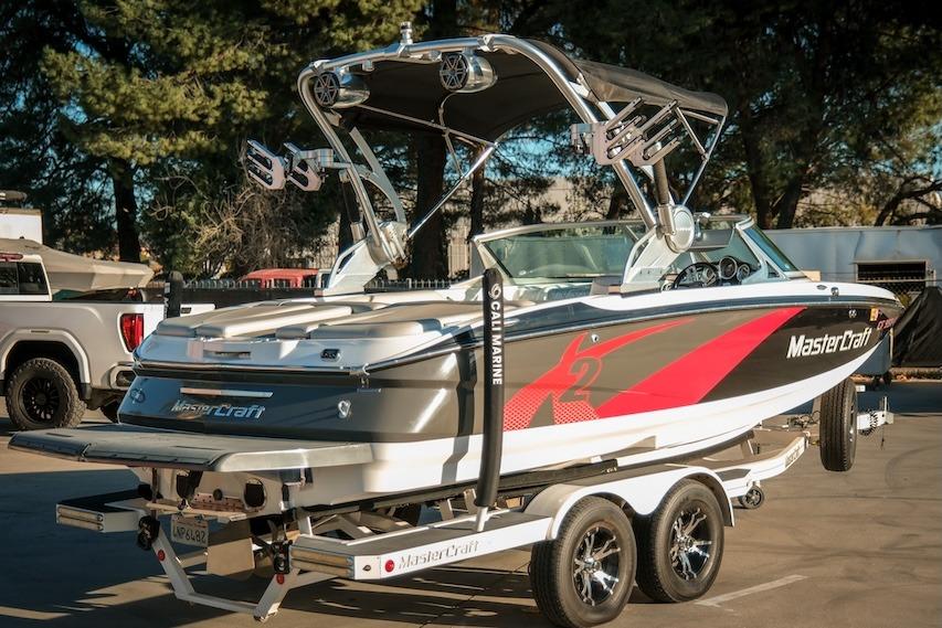 2013 MasterCraft X-2 boat on trailer, featuring sleek design and vibrant graphics.