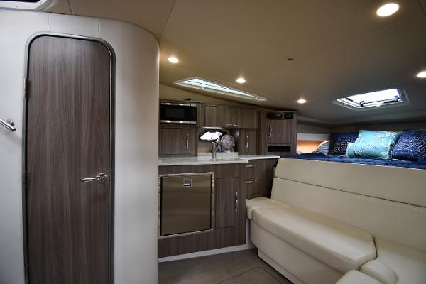 Luxurious interior of 2021 Regal 35 Sport Coupe with modern kitchen and cozy seating area.