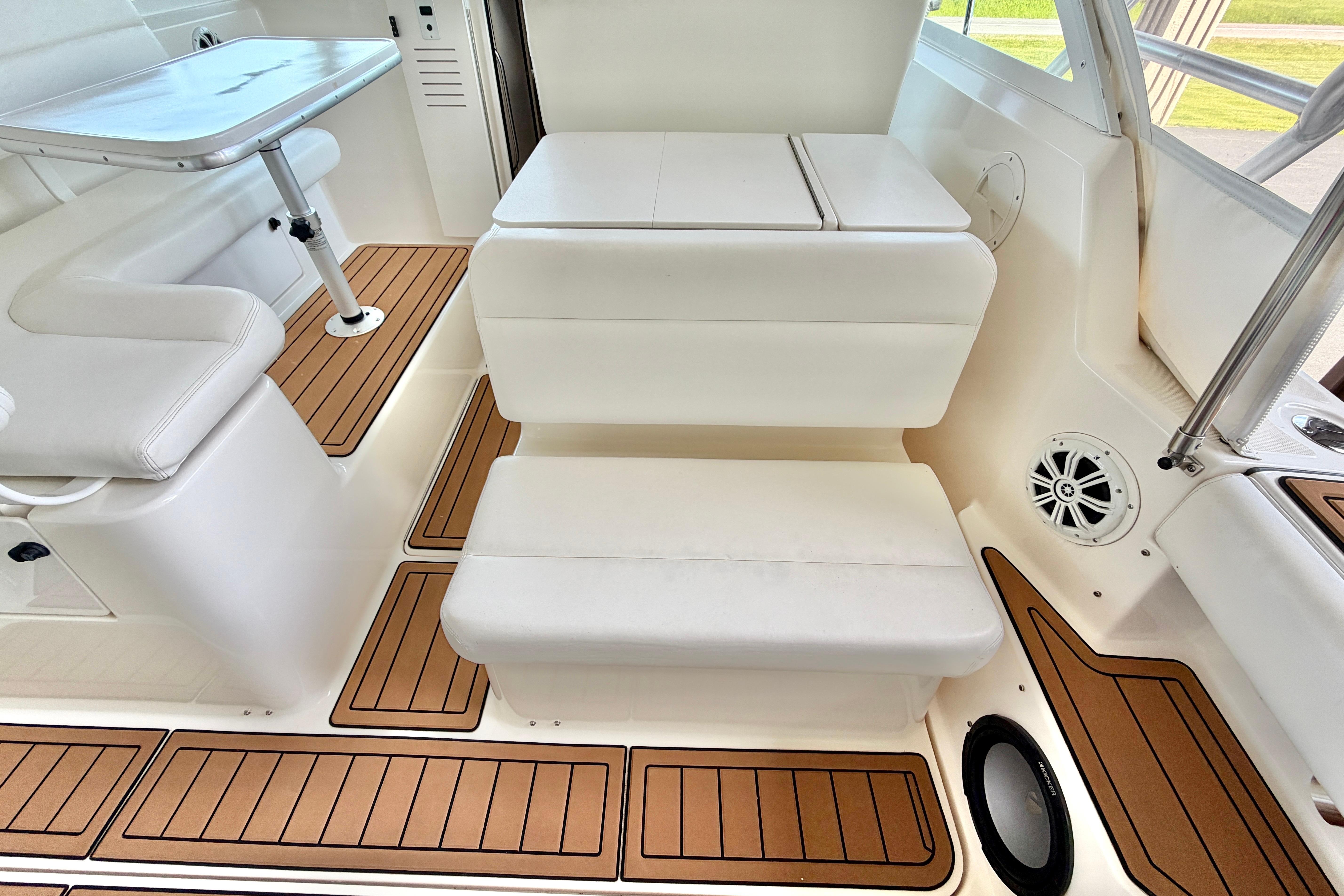 1999 Tiara Yachts 2900 Coronet interior with white seating and wood-accented flooring.
