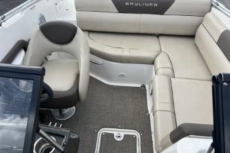 2017 Bayliner 195 Deck Boat interior with beige seating and steering console.