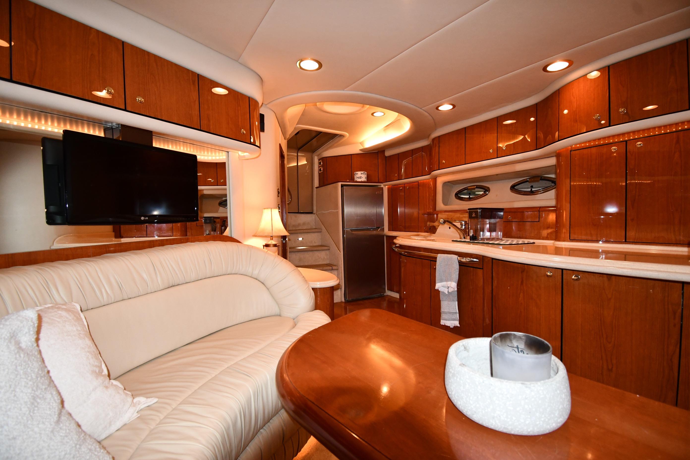 Luxurious interior of 2001 Sea Ray 540 Sundancer yacht with elegant wood finishes.