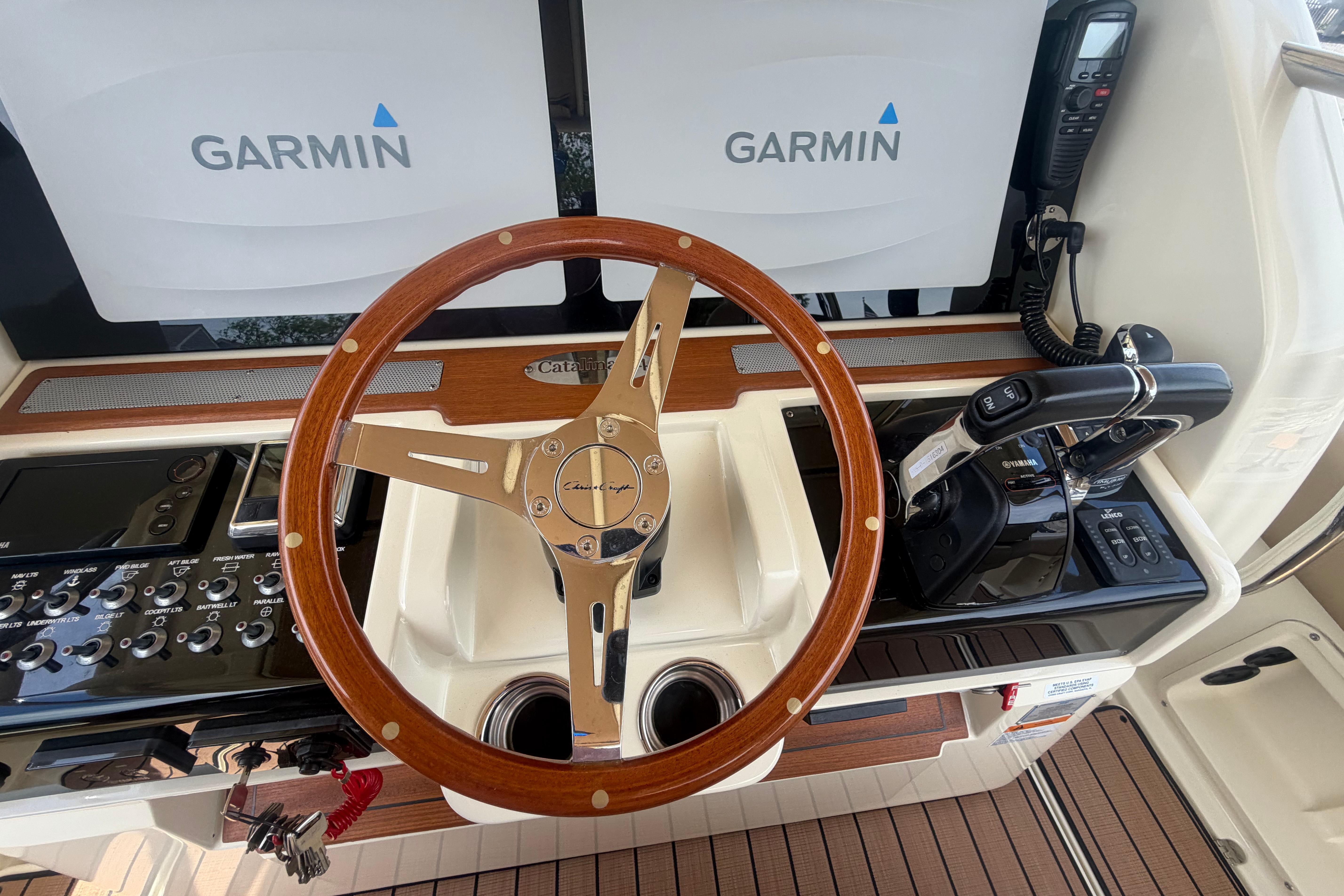 2017 Chris-Craft Catalina 34 helm with Garmin displays and wooden steering wheel.