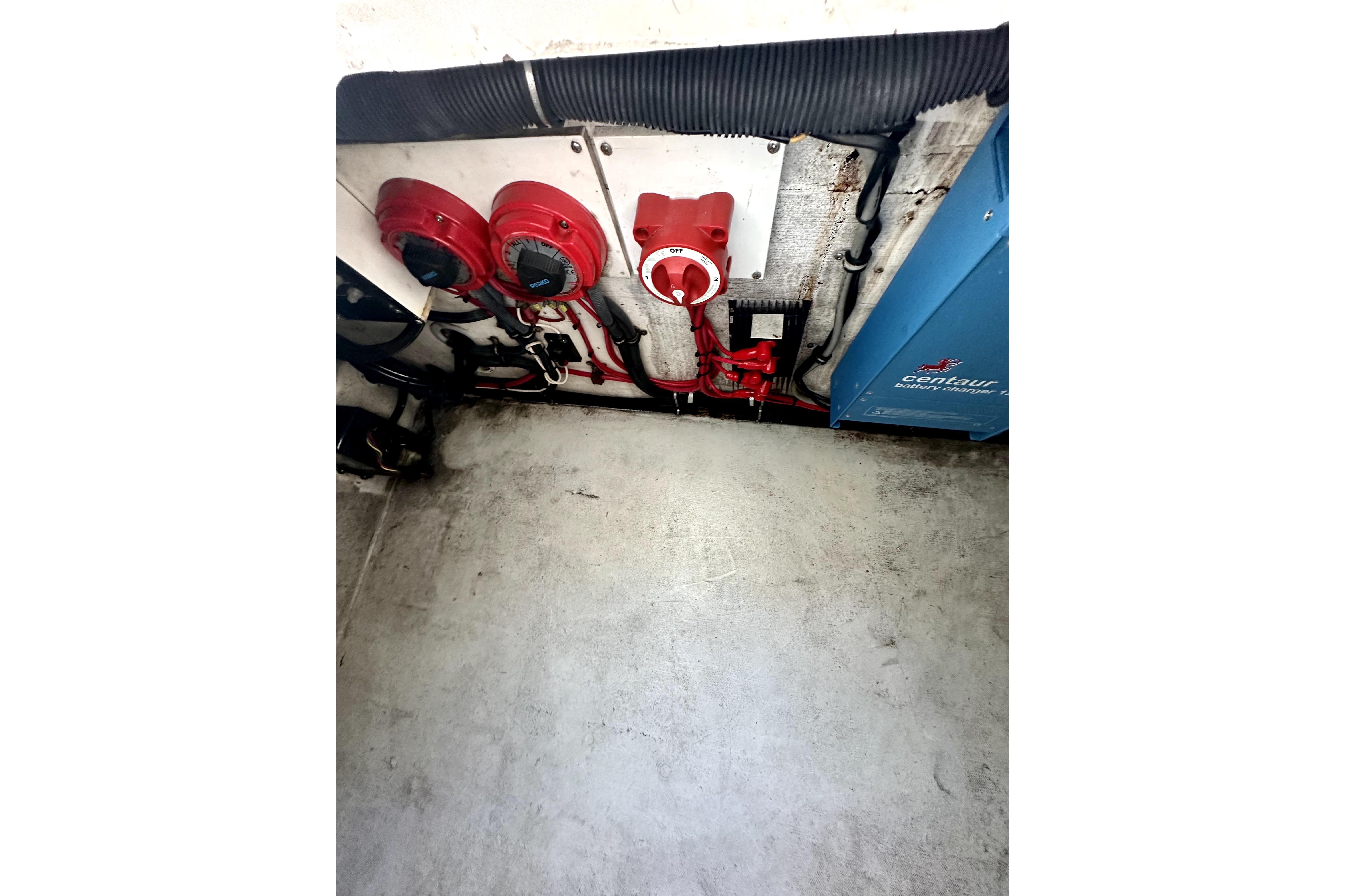 2006 Contender 35 Express Side Console engine compartment with red switches and wiring.