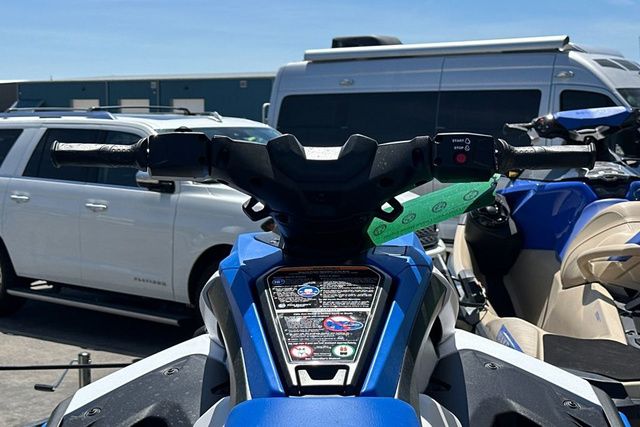 Close-up of a Yamaha WaveRunner Jetblaster's handlebars, surrounded by vehicles.