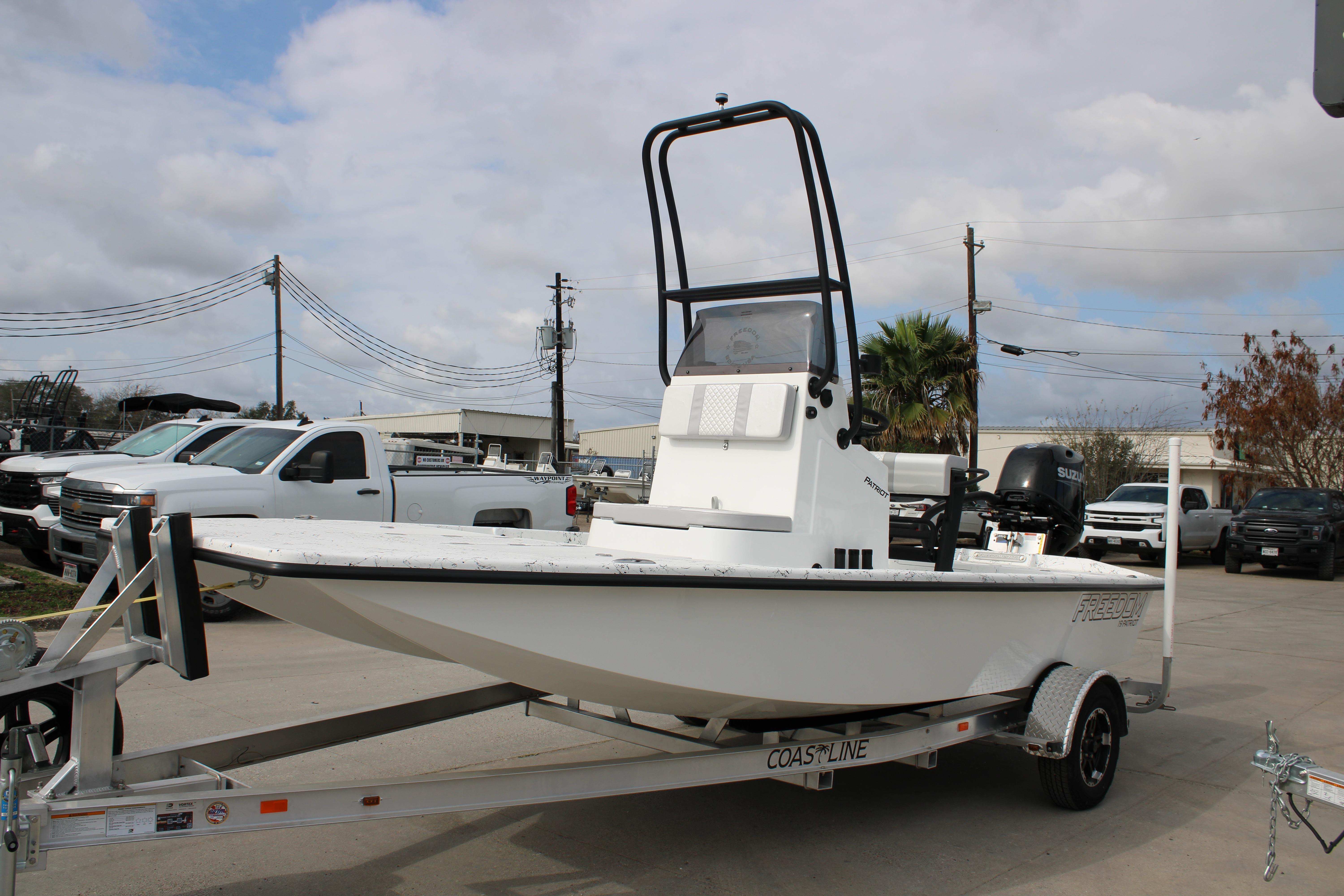 2026 Freedom Boats 19 PATRIOT on trailer, parked outdoors with cloudy sky.