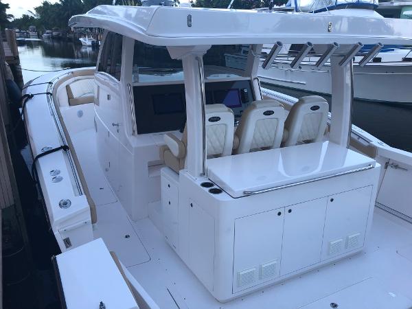 2019 Altima 38 Xcape boat with sleek design and spacious seating at a marina.