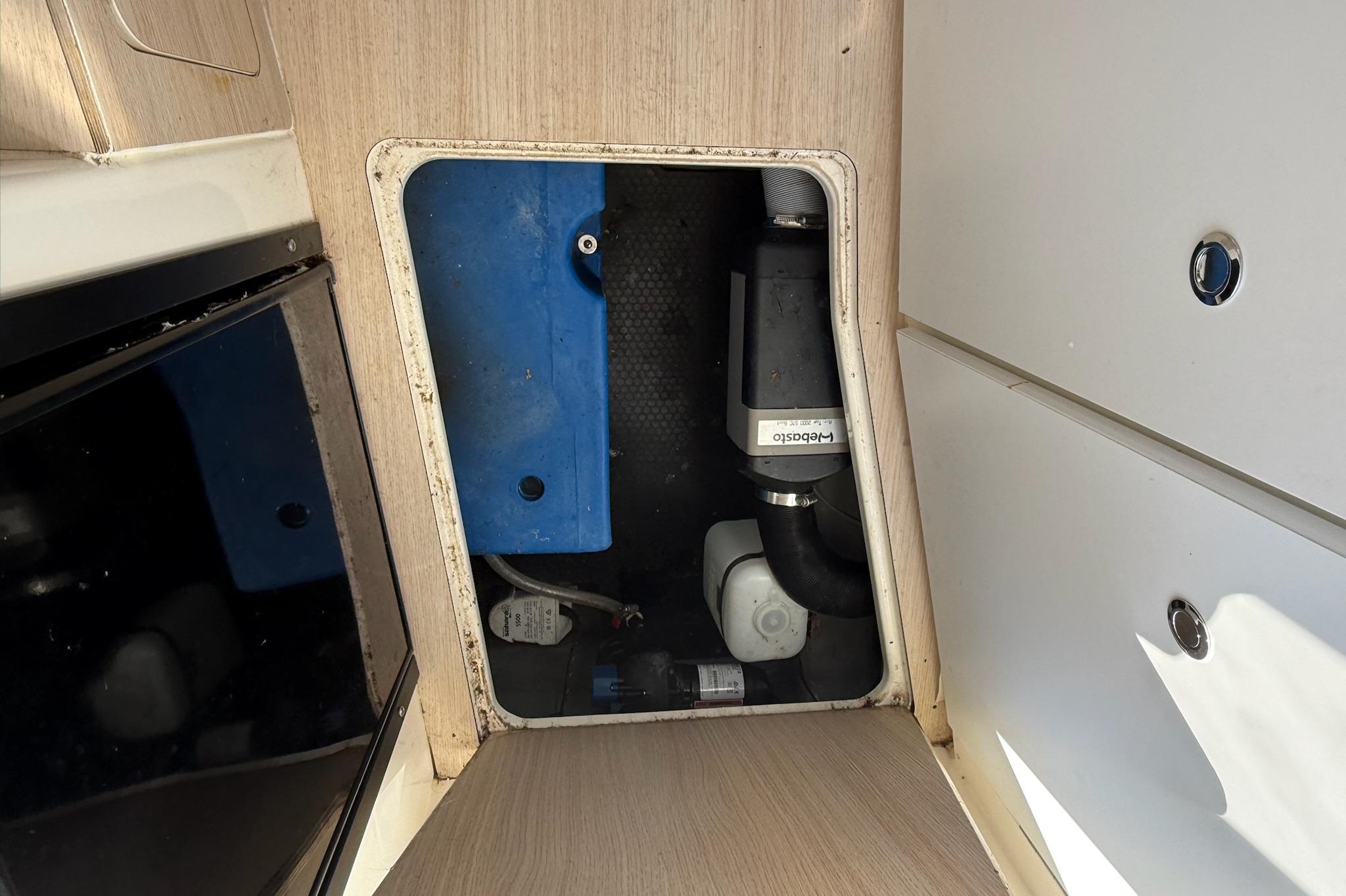 2024 Bayliner Trophy T25 Pilothouse interior compartment with visible equipment and storage.