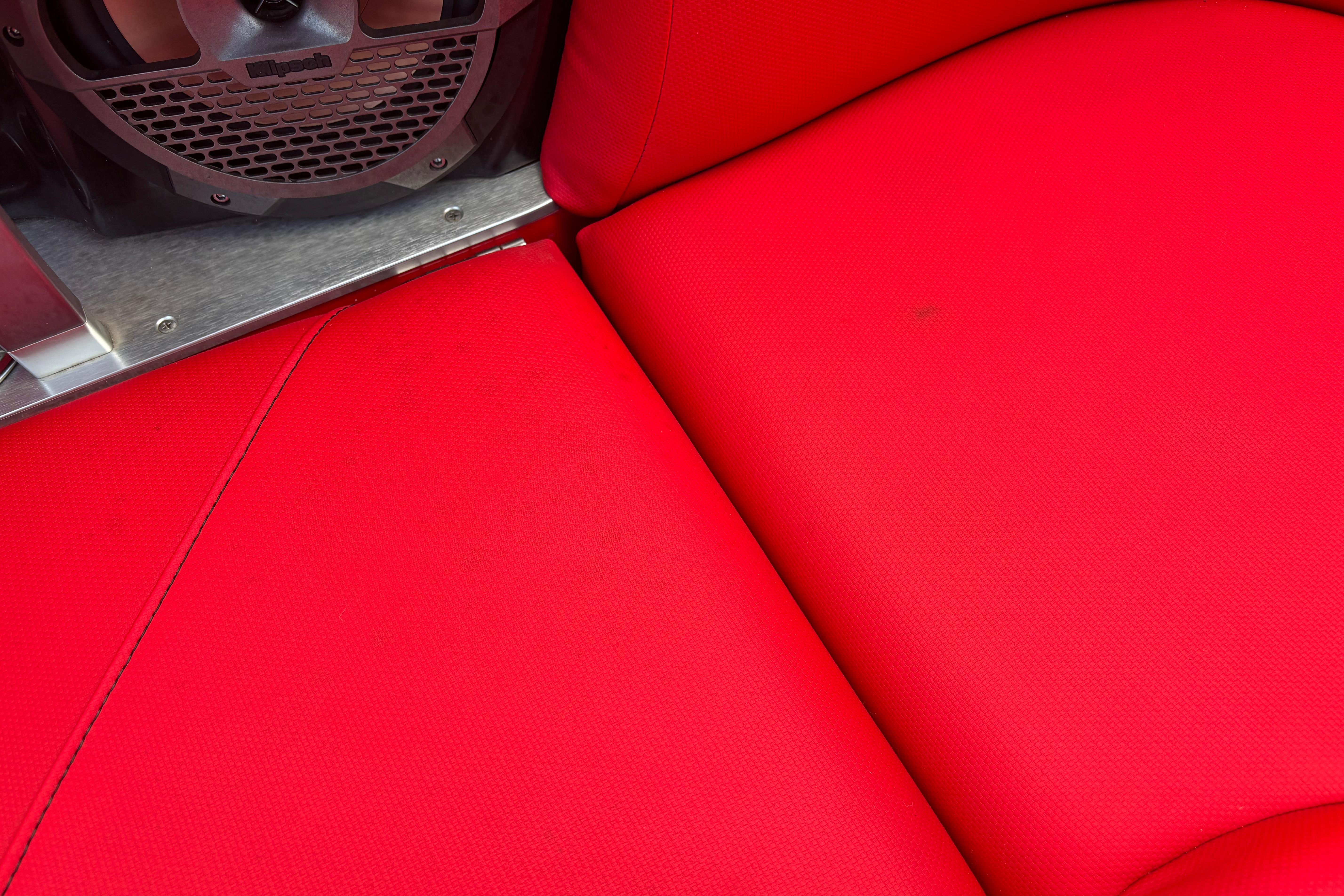 Red upholstery and speaker detail in 2020 MasterCraft X24 boat interior.