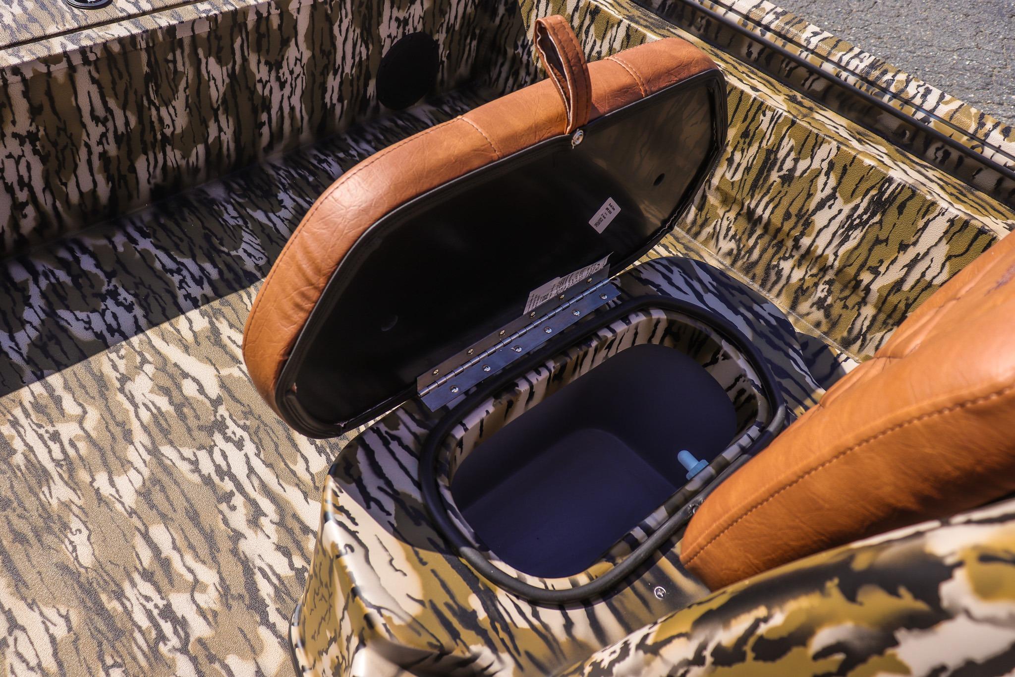 Open storage compartment in a 2027 Avid 20 Rogue CC boat with camouflage pattern.