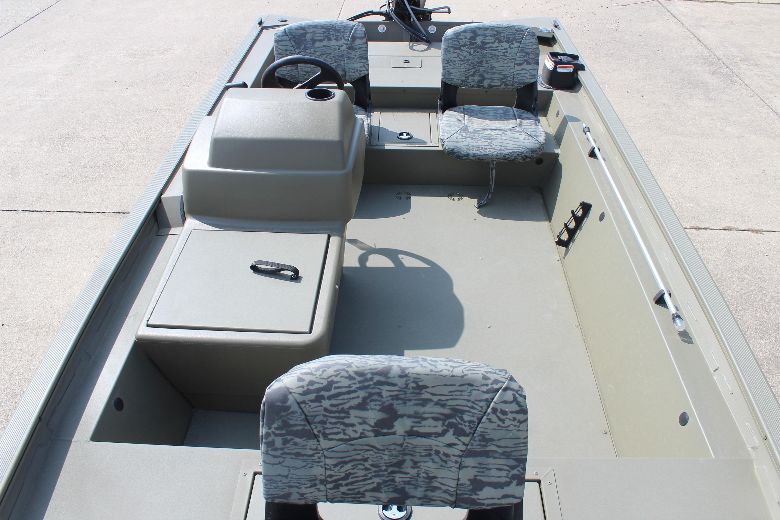 2026 Tracker Grizzly 1754 SC boat interior with camo seats and steering console.