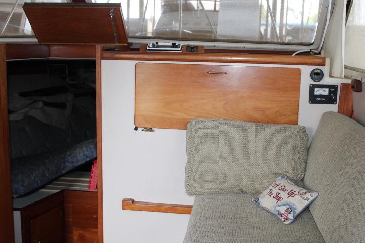 Interior of 1988 Tollycraft 30 Sport Cruiser with cozy seating and nautical decor.