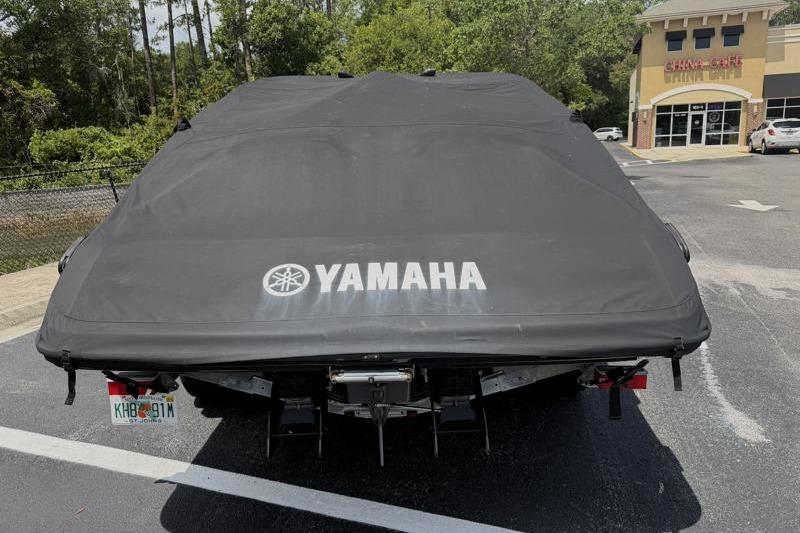 Covered 2017 Yamaha SX210 boat in parking lot, rear view.