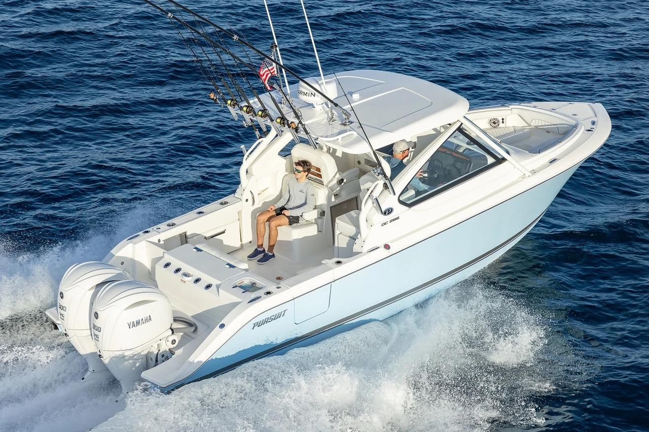 Manufacturer Provided Image: 2026 Pursuit DC 286 Dual Console boat cruising on open water with fishing rods.