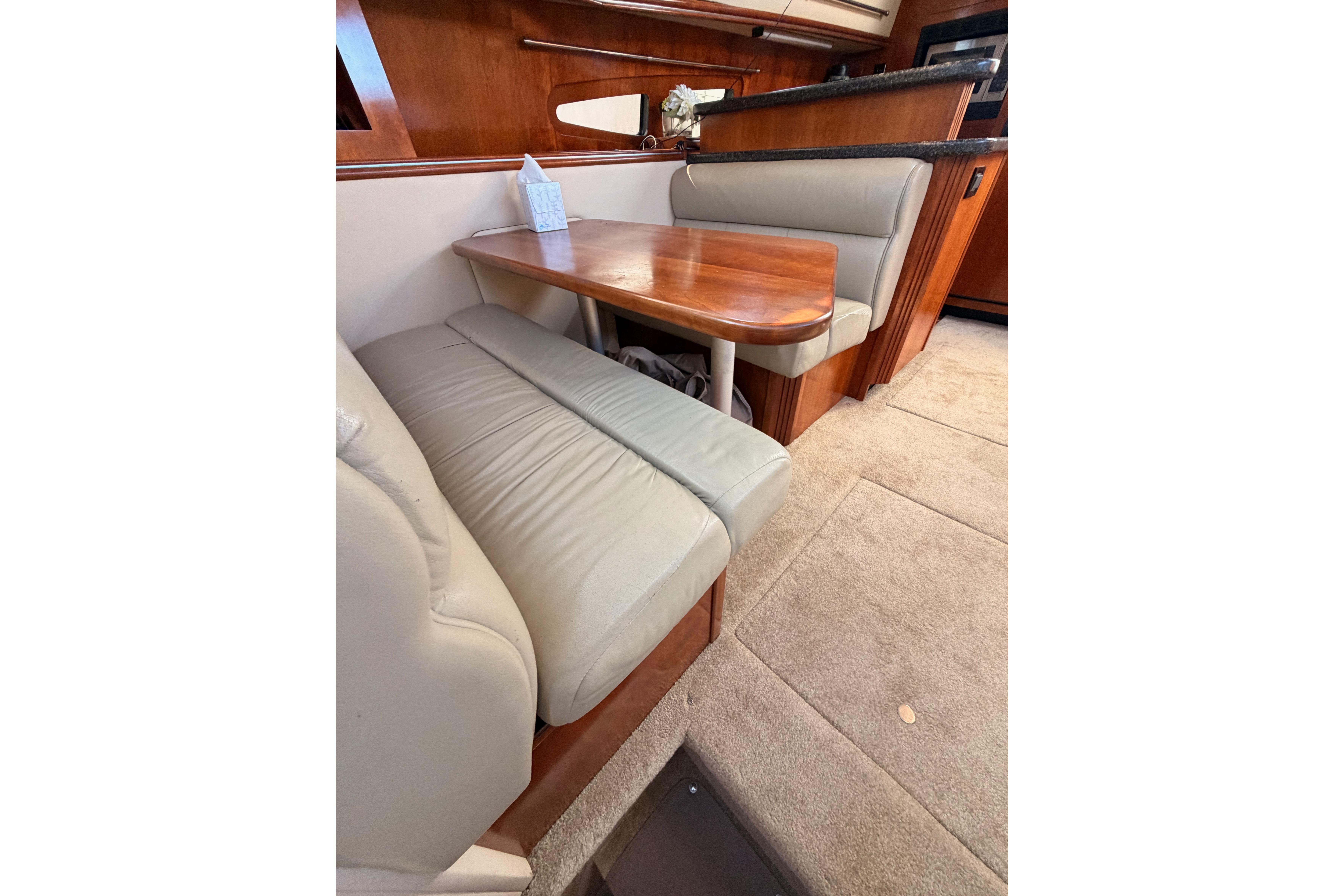 2005 Cruisers Yachts 405 Express Motoryacht interior dining area with cushioned seating.