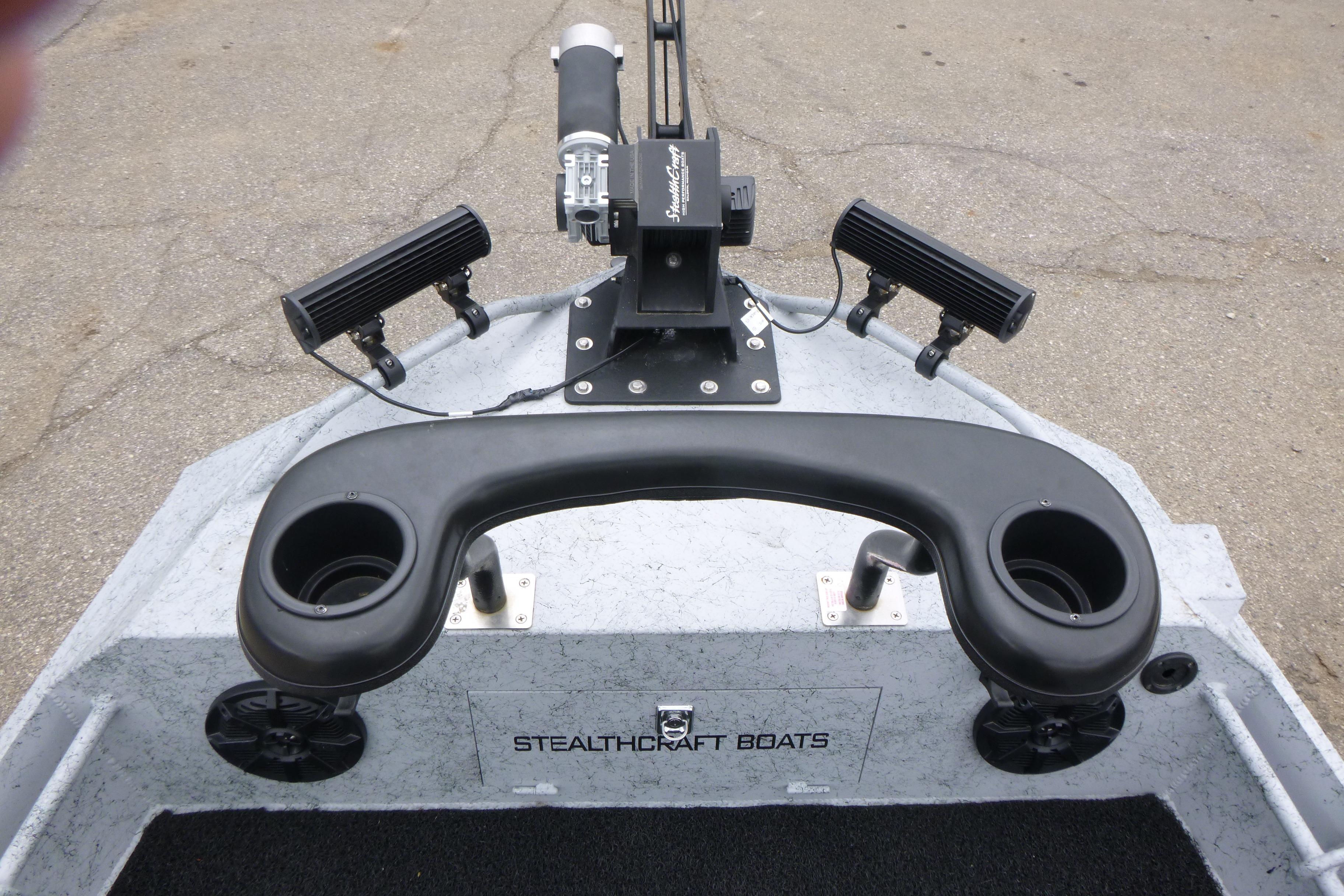2025 StealthCraft 16 StealthWeld boat with rod holders and steering console.