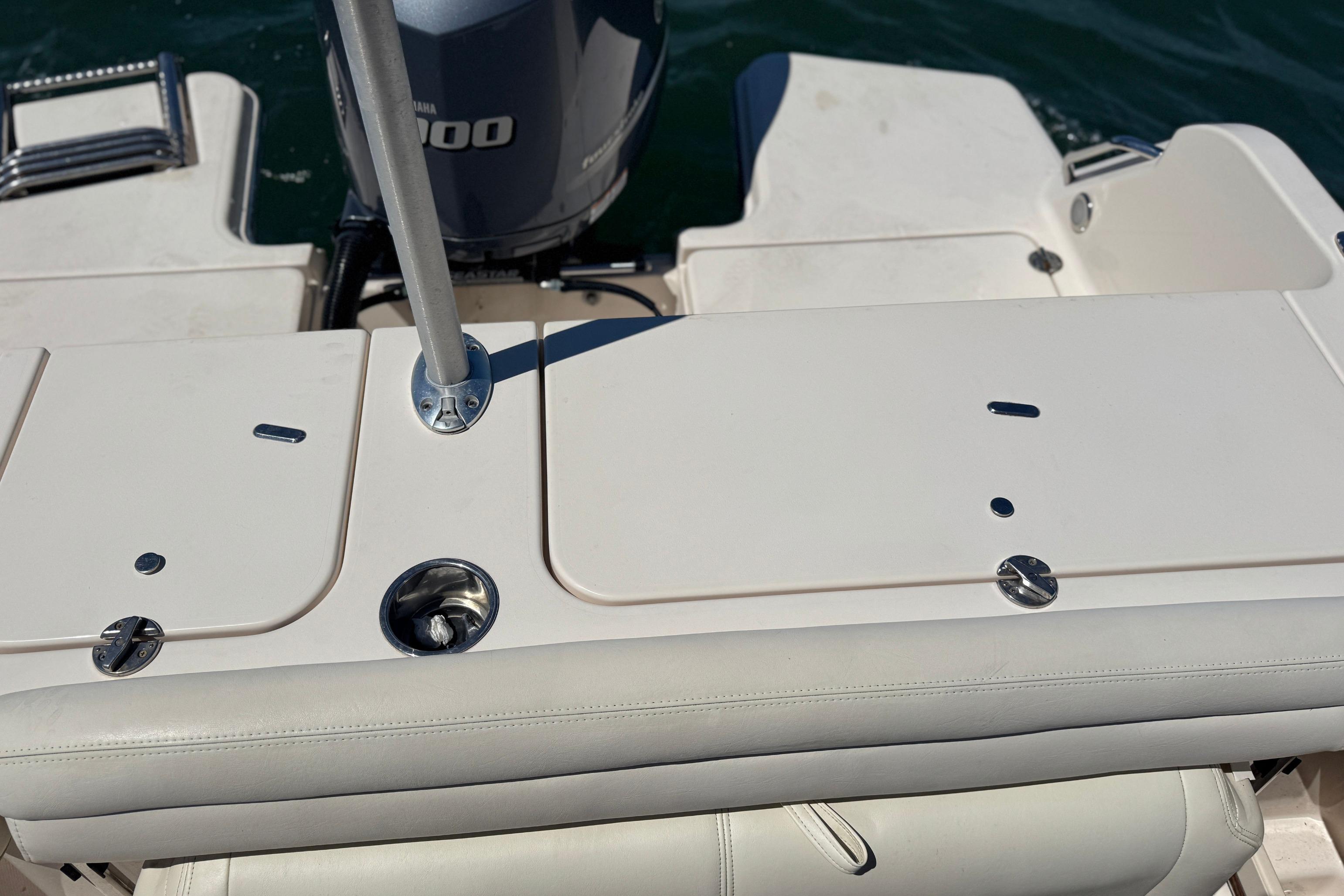 2017 Grady-White Freedom 235 boat deck with Yamaha engine, featuring storage compartments and seating.