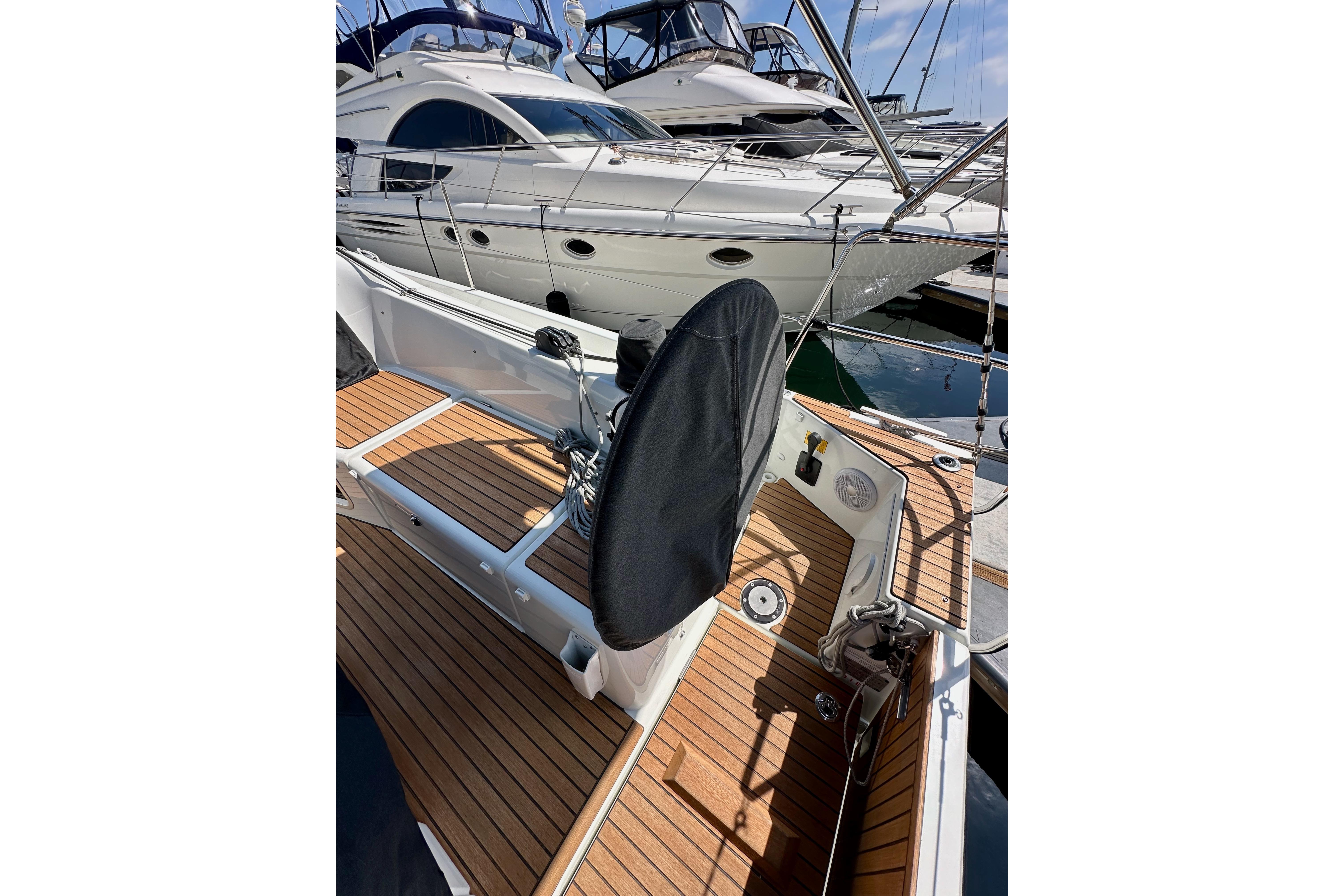 2024 Jeanneau Sun Odyssey 410 sailboat with teak deck, docked at marina.