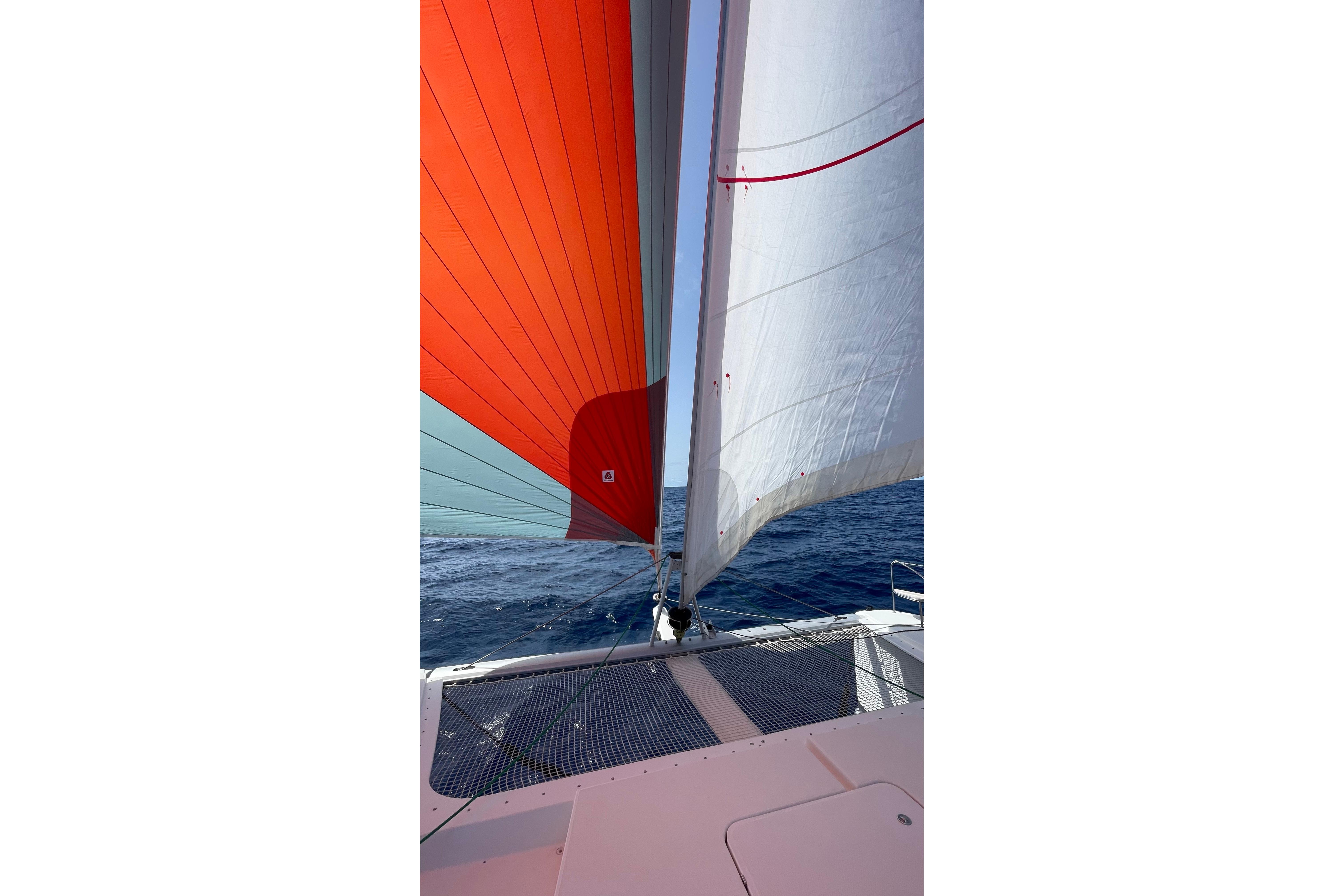 Fountaine Pajot Saona 47 sailing with vibrant sails on open sea, 2020 model.