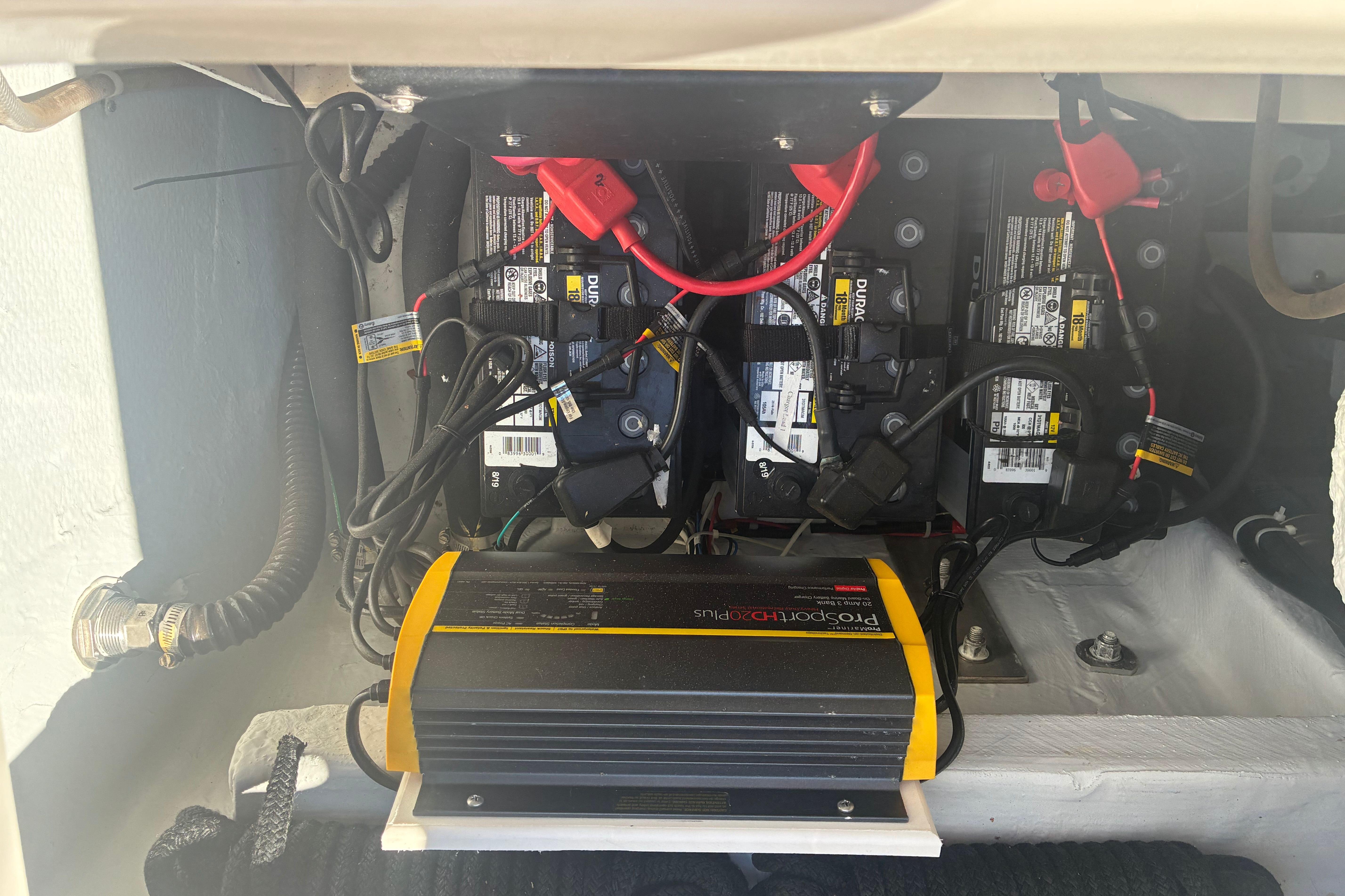 Battery compartment of a 2014 Grady-White Gulfstream 232 boat with charger and wiring.