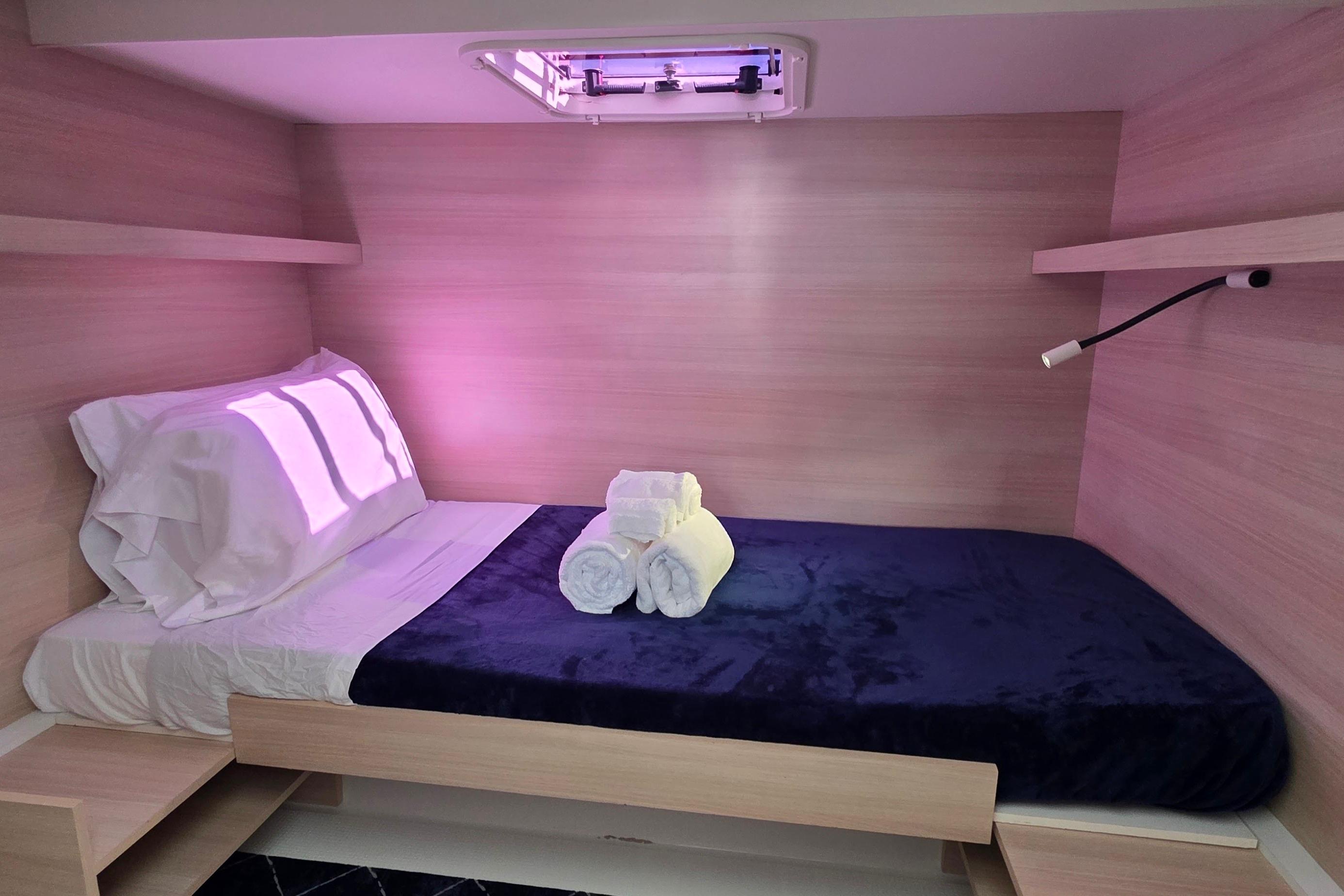 Cozy cabin interior of 2018 Fountaine Pajot Motor Yacht 44 with bed and soft lighting.
