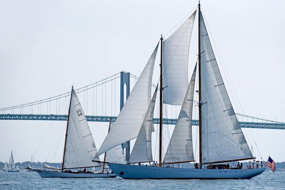Sailboats on water with bridge backdrop, featuring 1939 William McMeek Brooks Marine model.