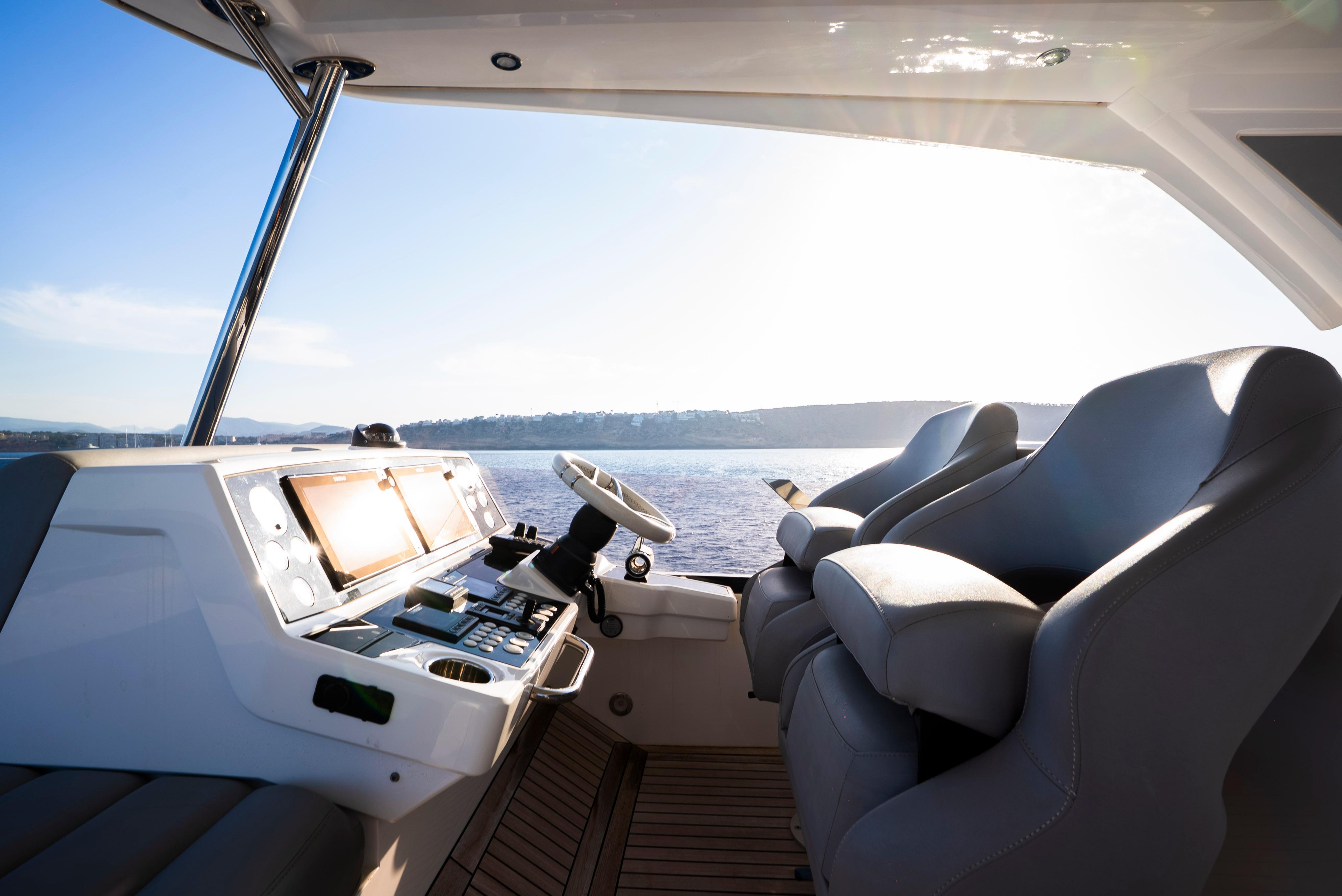 Interior view of 2017 Sunseeker Manhattan 66 yacht helm with ocean backdrop.