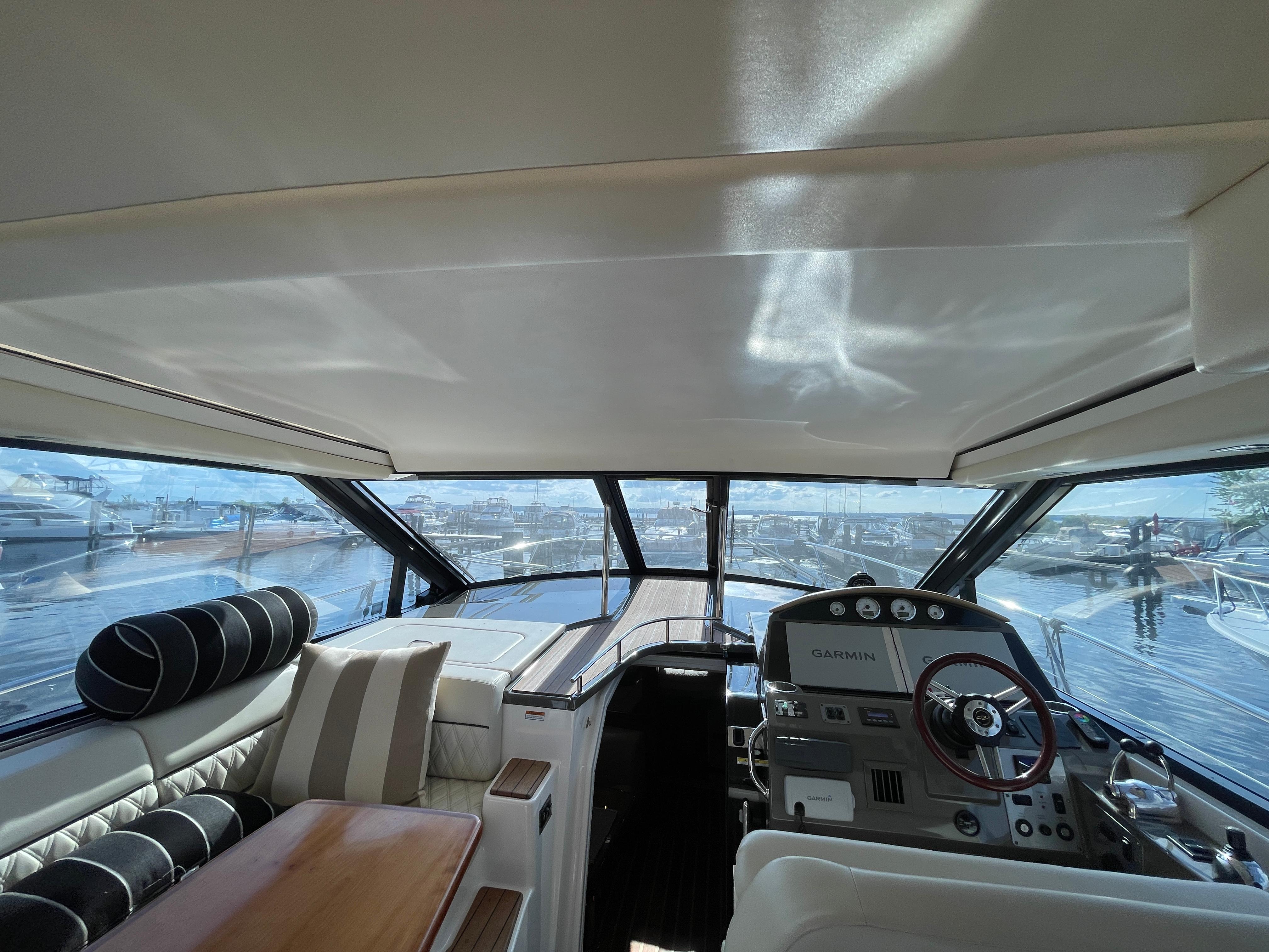 Interior view of 2010 Regal 44 Sport Coupe yacht with modern helm and seating.