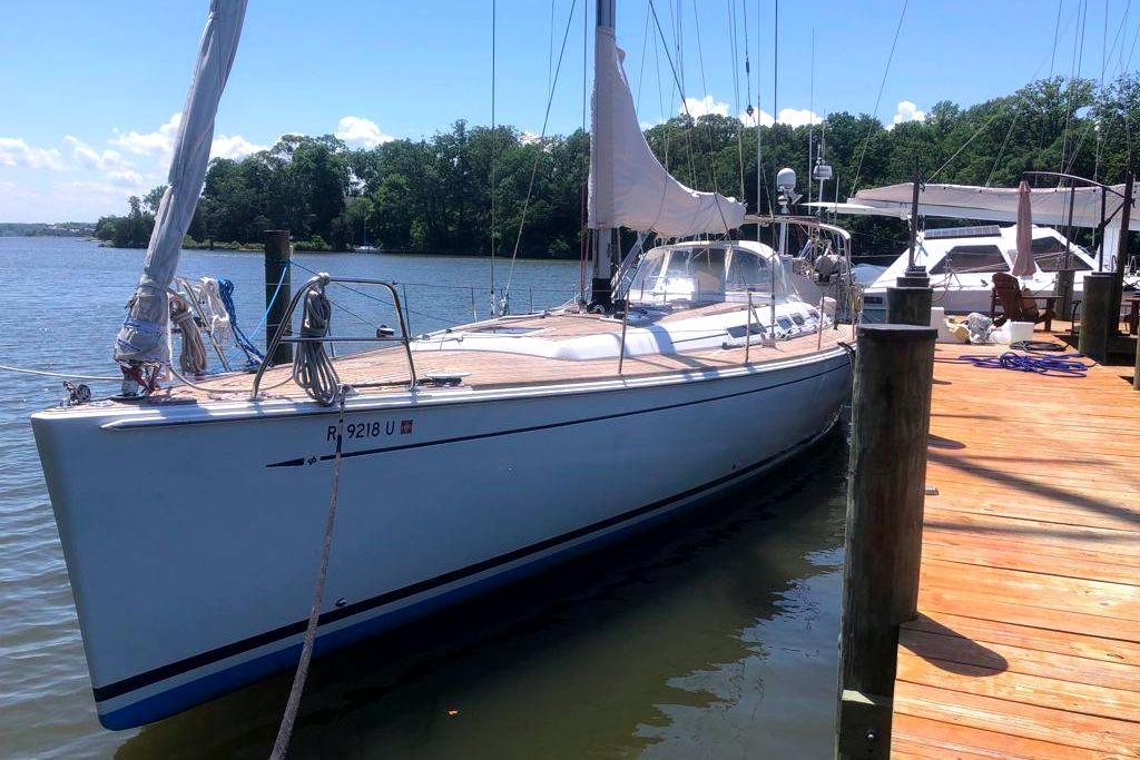 2006 Grand Soleil 50 sailboat docked by a wooden pier on a sunny day.